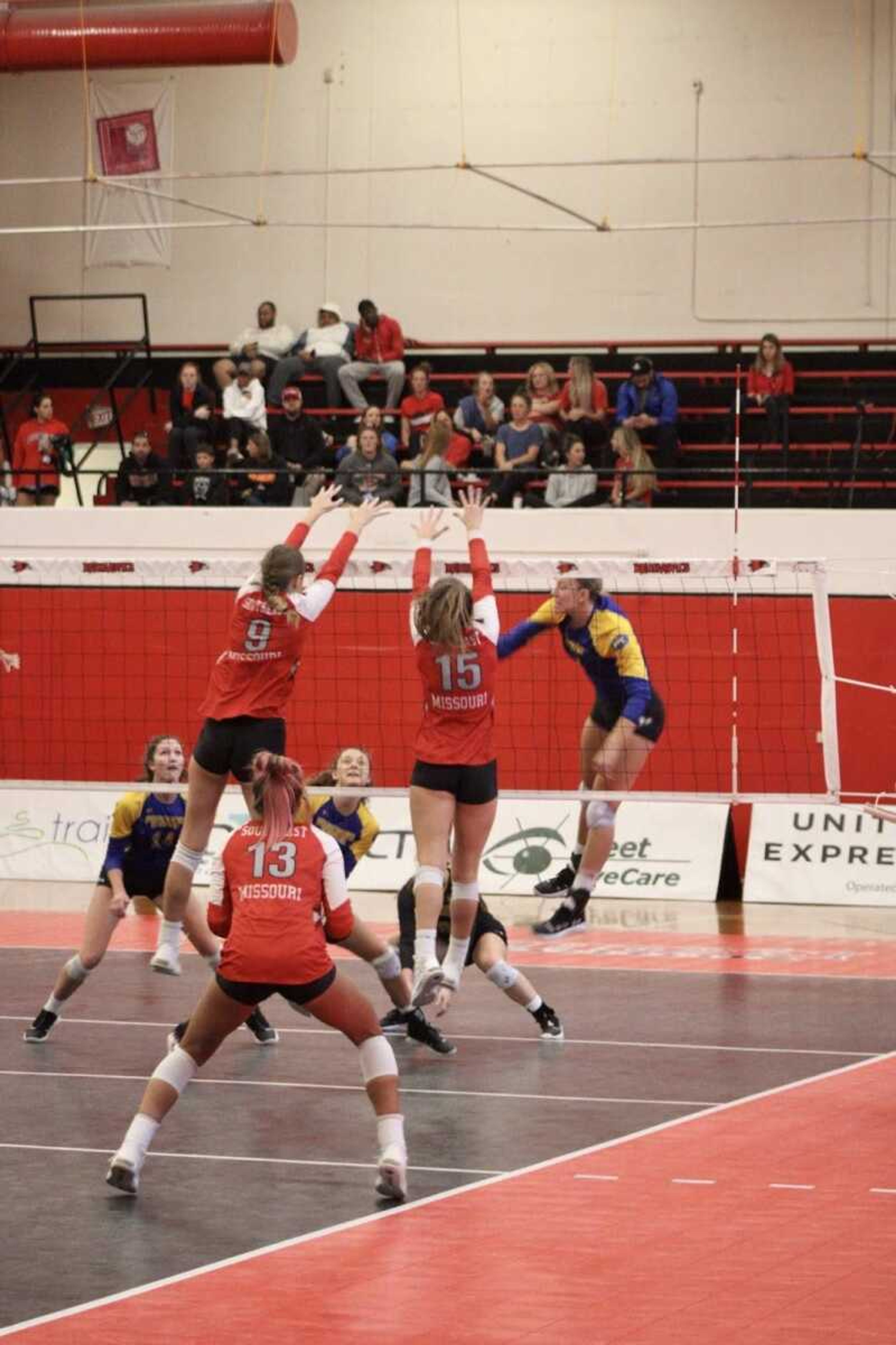 Senior Krista Berns (#9) and sophomore Claire Ochs (#15) go up for a block against Morehead State on Oct. 18 at Houck Field House.