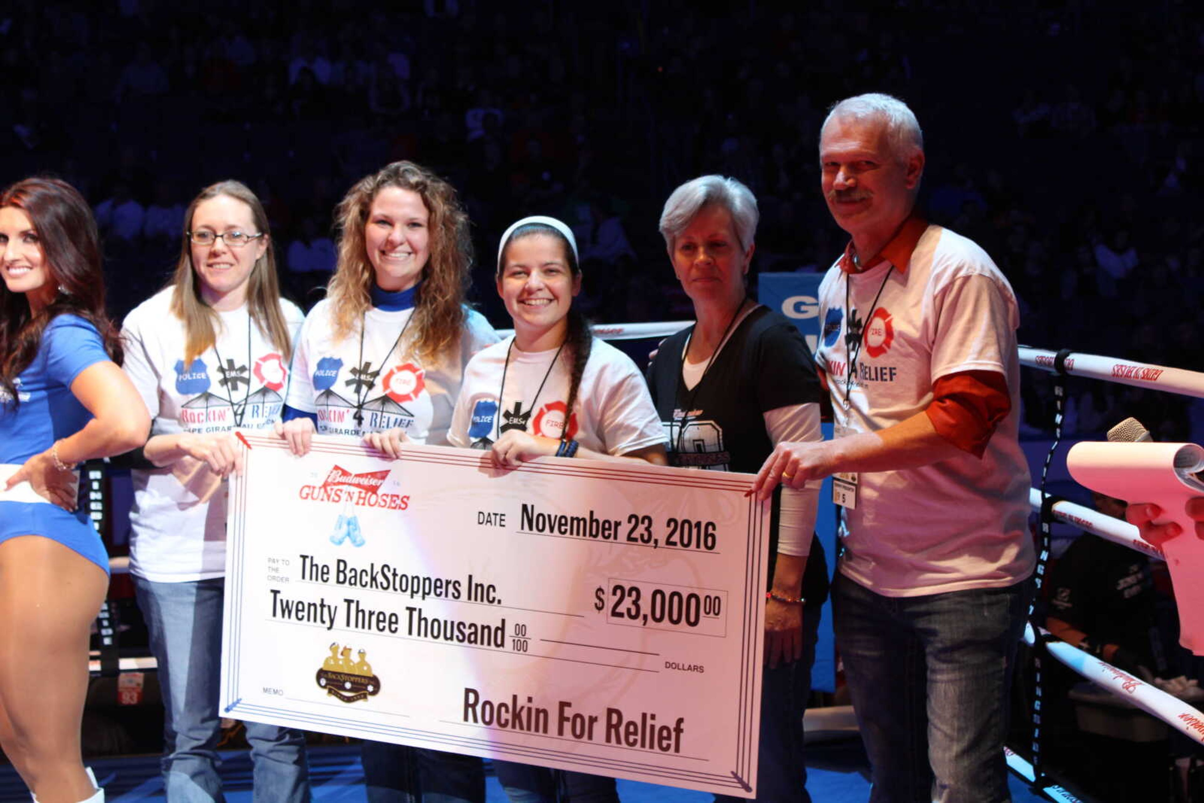 From left to right Carolyn Curtis, Carly Howell, Jennifer Rubin, Jacqueline Bettale and Al Spener present a check for $23,000 from Rockin’ 4 Relief at Guns ‘N Hoses on Nov. 23.