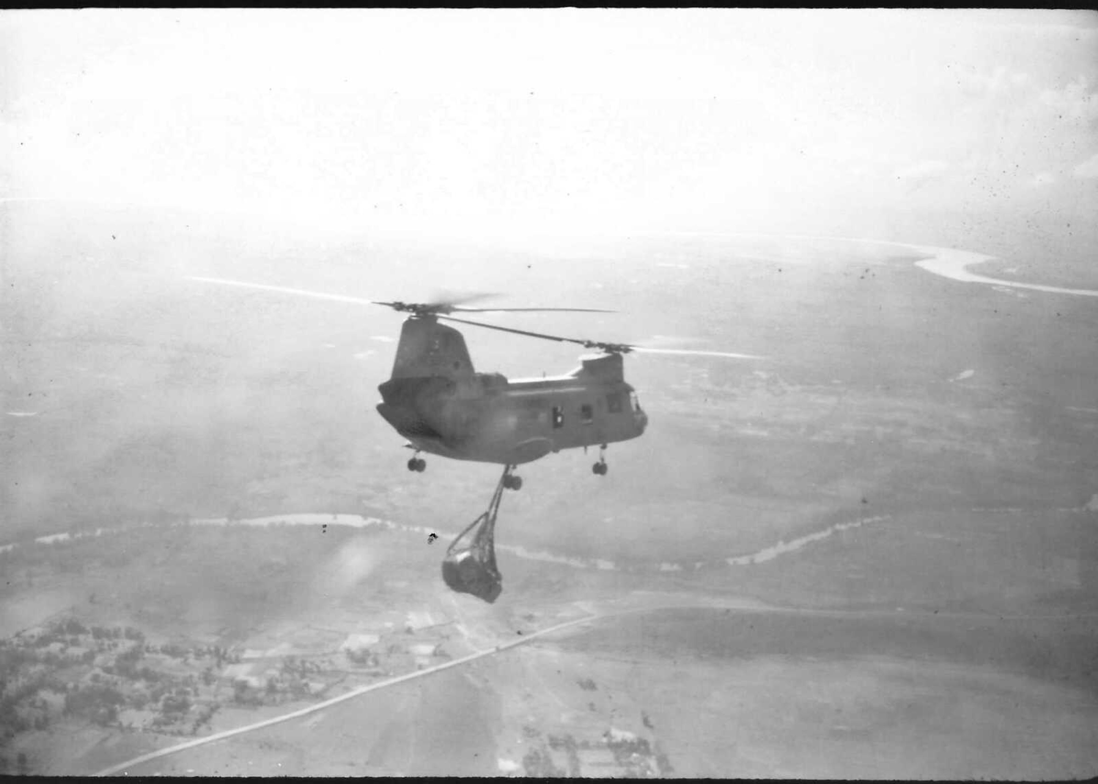 A CH-46 helicopter, piloted by First Lt. Harold Walker, resupplying Marines in Vietnam, 1969-1970.