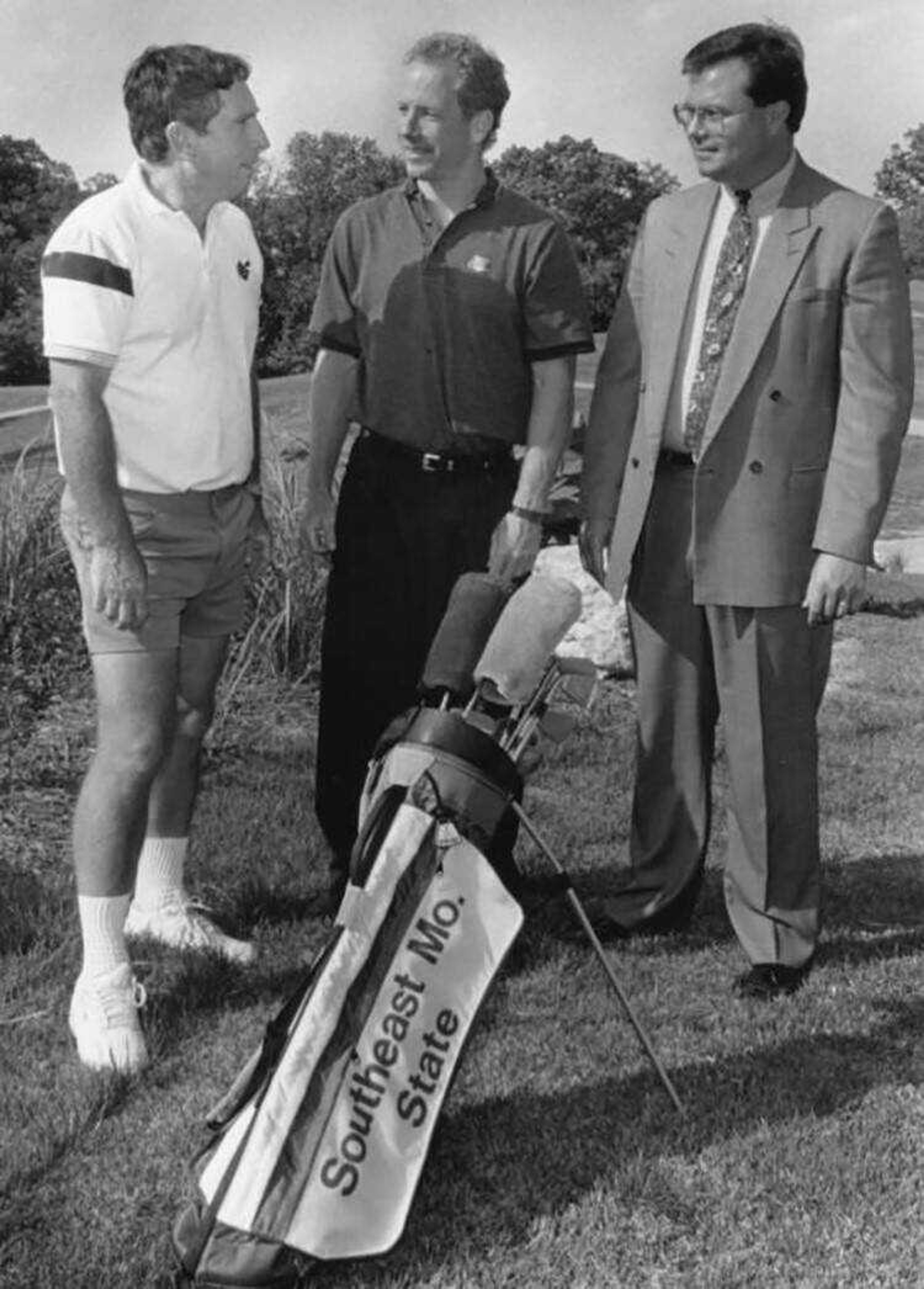 Former Southeast golf coach Carroll Williams (left) stands at Bent Creek Golf Club before a tournament in 1992.