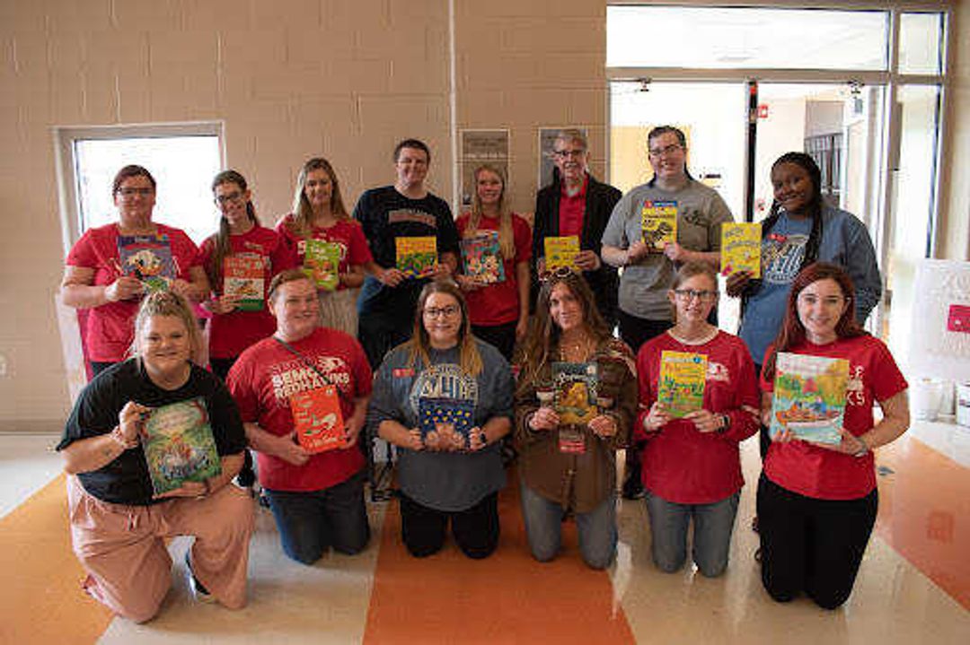 SEMO SMSTA poses with their donated books before handing them out to the kindergarten and first grade students at Franklin Elementary. The wide variety of books were compiled from members of SMSTA. 
