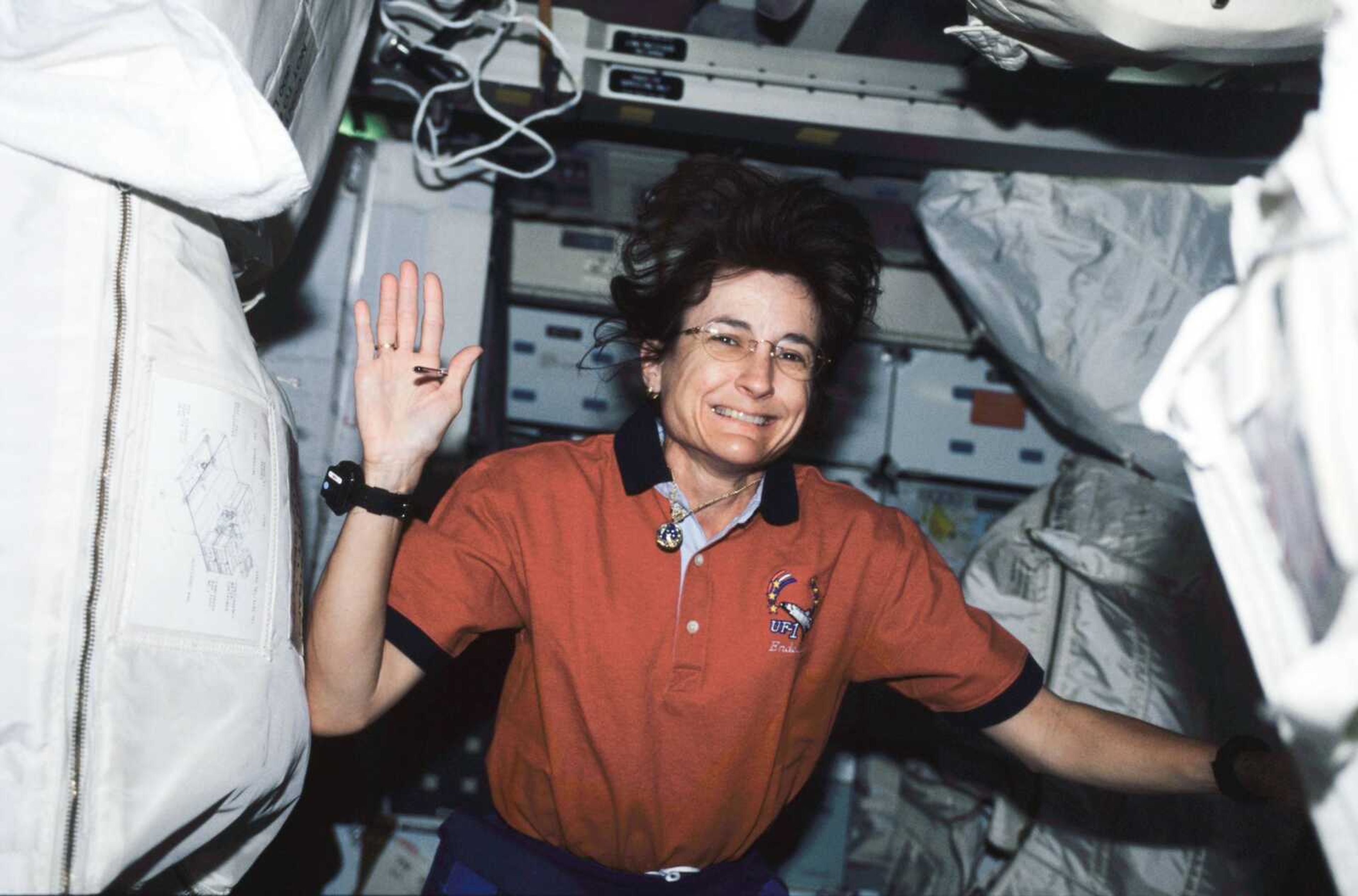 Linda Godwin waves while she transfers stowage goods from Endeavour to the International Space Station.

