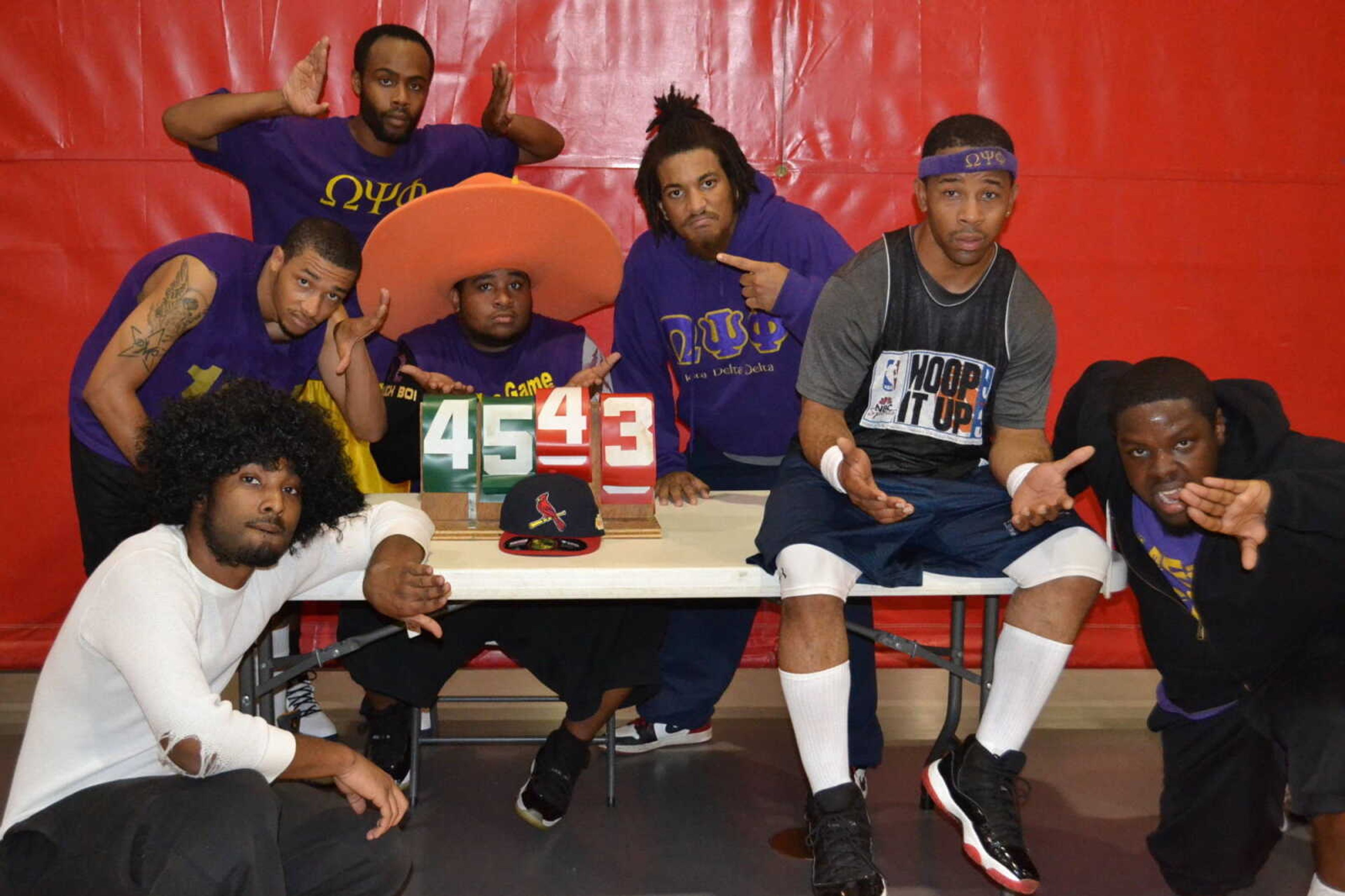 Top: Omega Psi Phi members Joshua Powell, Desmond Bryant, Remington Kelly, Thomas Nellums, Jamar Dowdy, Dominique Bailey and Tajai Sullivan after their victory against the Alpha Phi Alpha fraternity in a charity basketball game. - Submitted photo