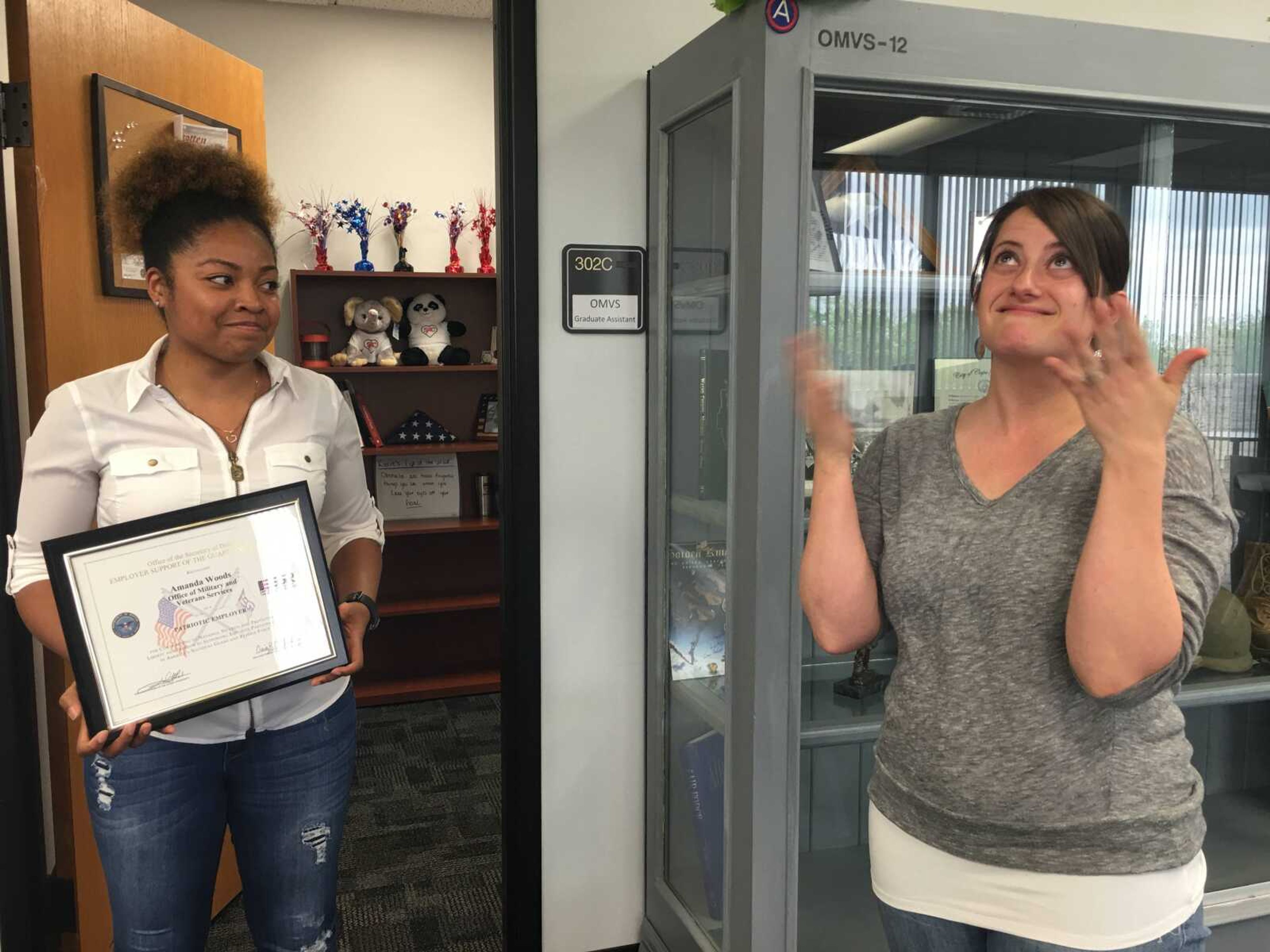 Amanda Woods (right) gets emotional upon receiving from the Patriot Award from Michellé Lang April 24 in the Office of Military and Veteran Services