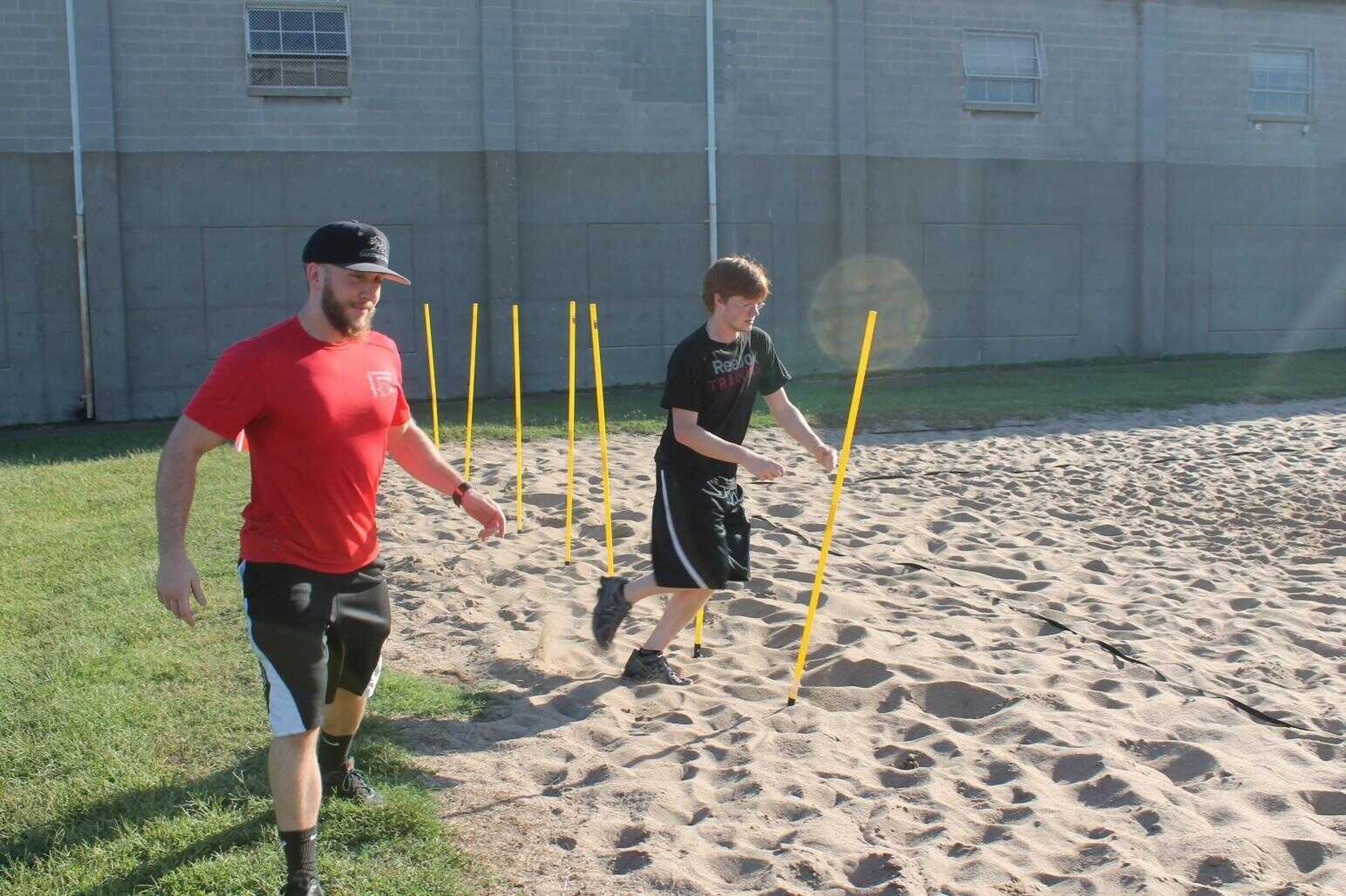 Justin Marks coached student as he attempts to complete the obstacle course.