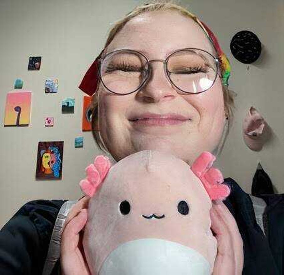 Rorie poses with an axolotl Squishmallow. “Archie is my favorite because he was one of the first ones that I got, and he is an axolotl, which is one of my favorite animals! I think they’re neat,” early childhood education junior Lydia Rorie said.
