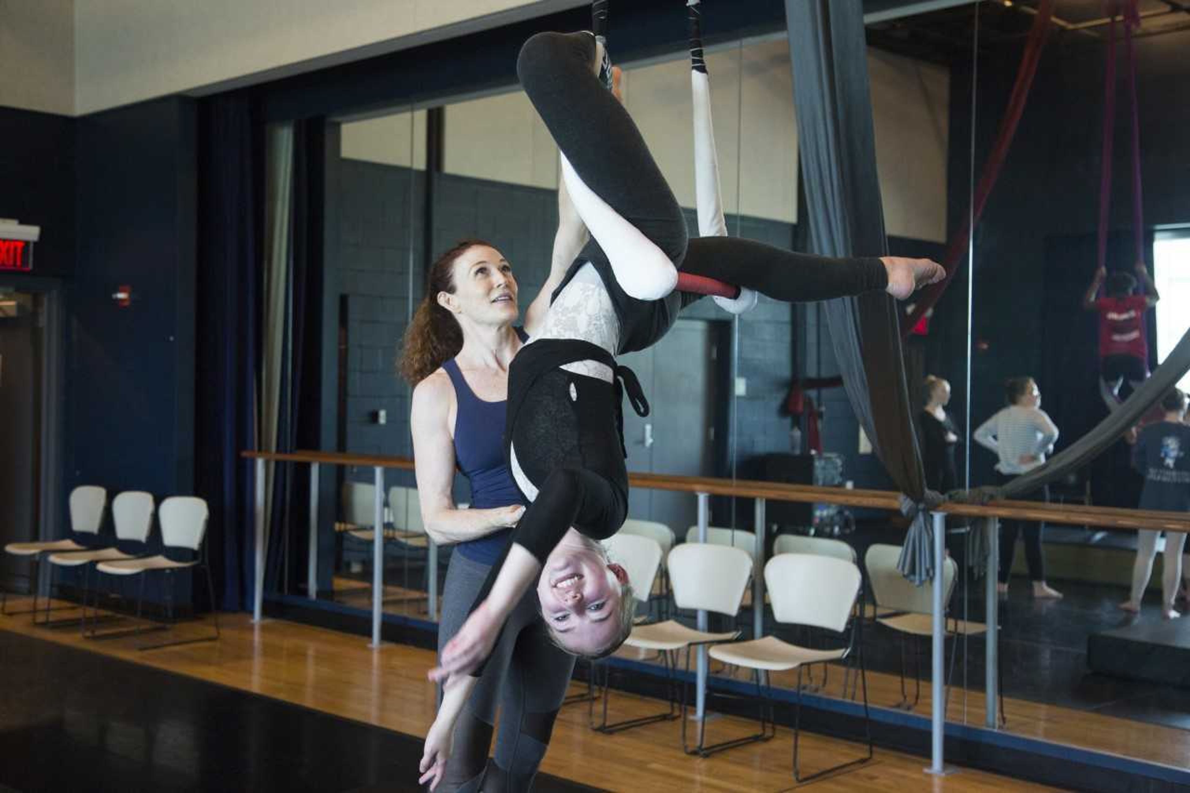 Dance instructor Hilary Peterson is guided on the trapeze by aerial dance instructor and Edge studio owner Lauren Jones.