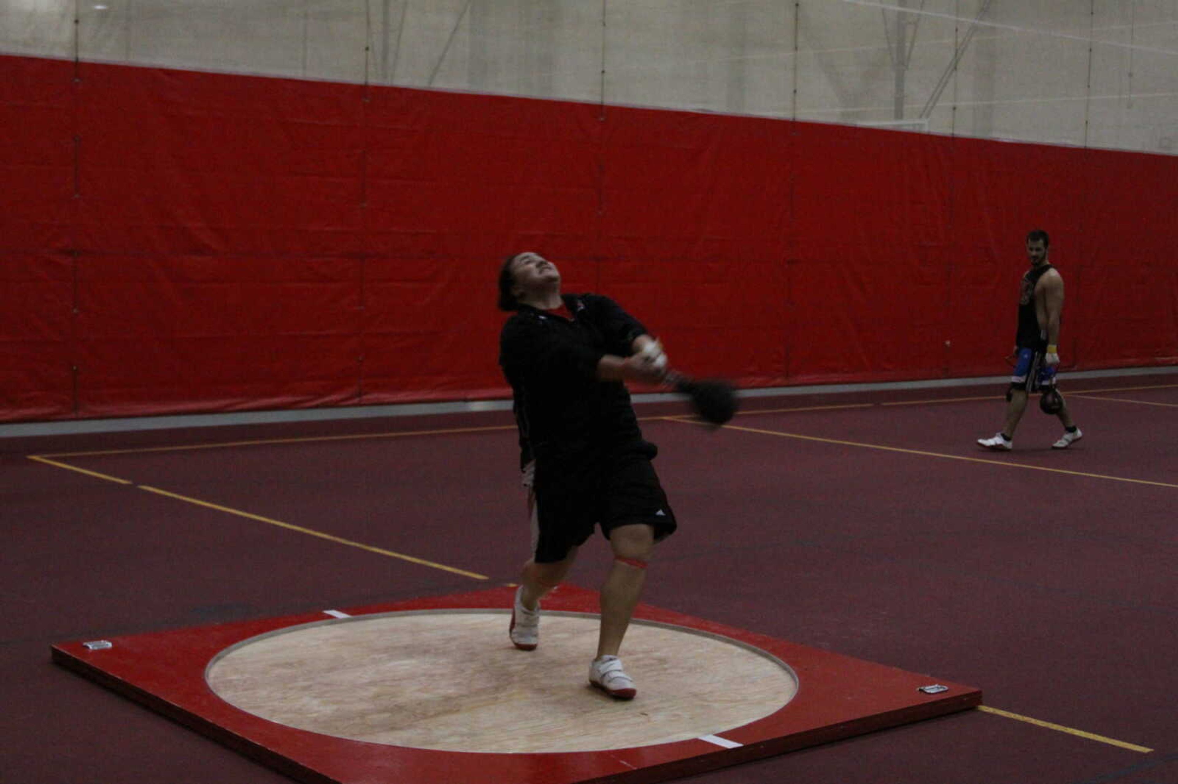Courtney Gapula practices the weight throw at an indoor practice on Feb. 1. - Photo by Kelso Hope