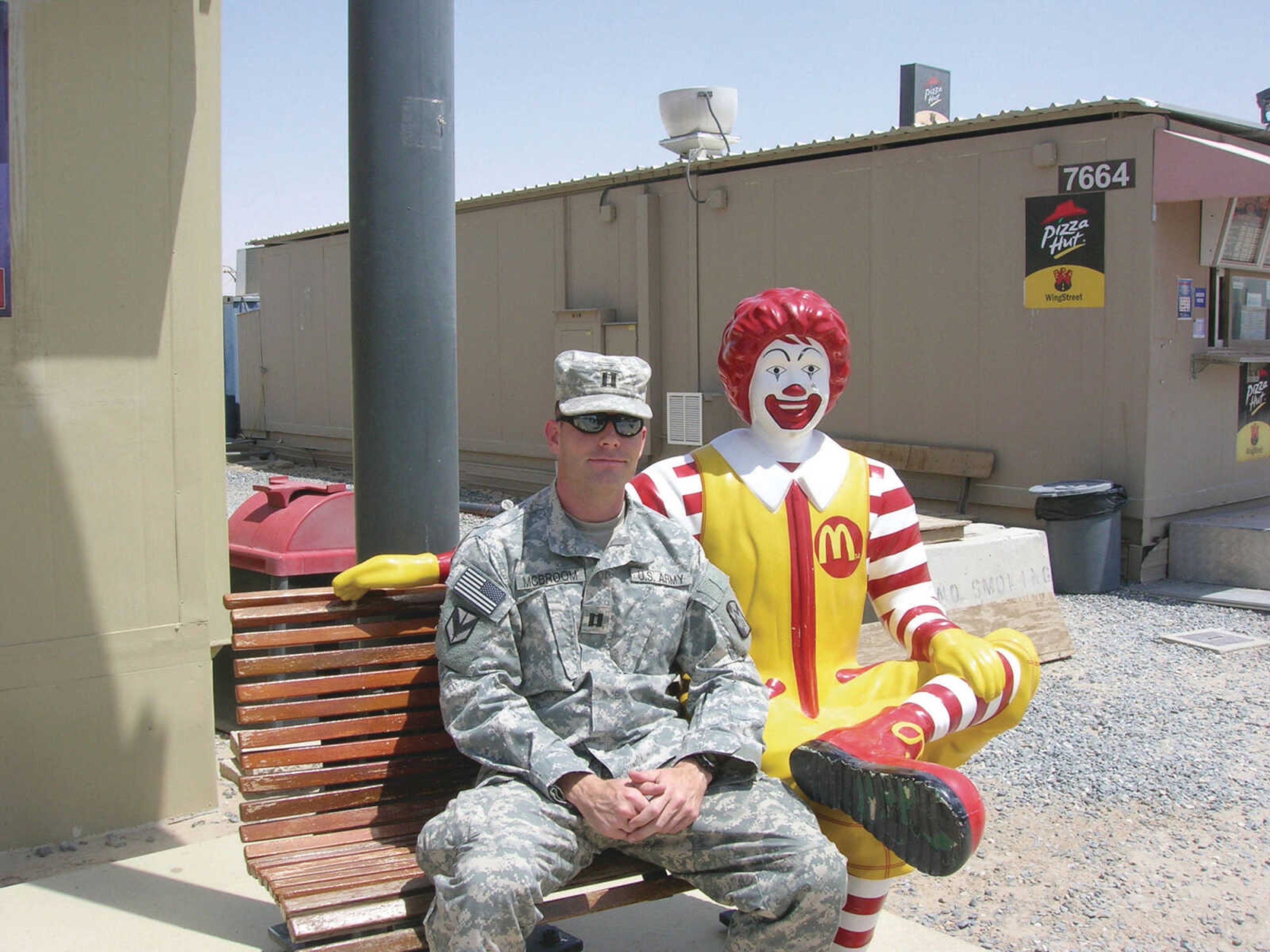  Jeremy McBroom sits next to a Ronald McDonald statue in Kuwait. Submitted photo