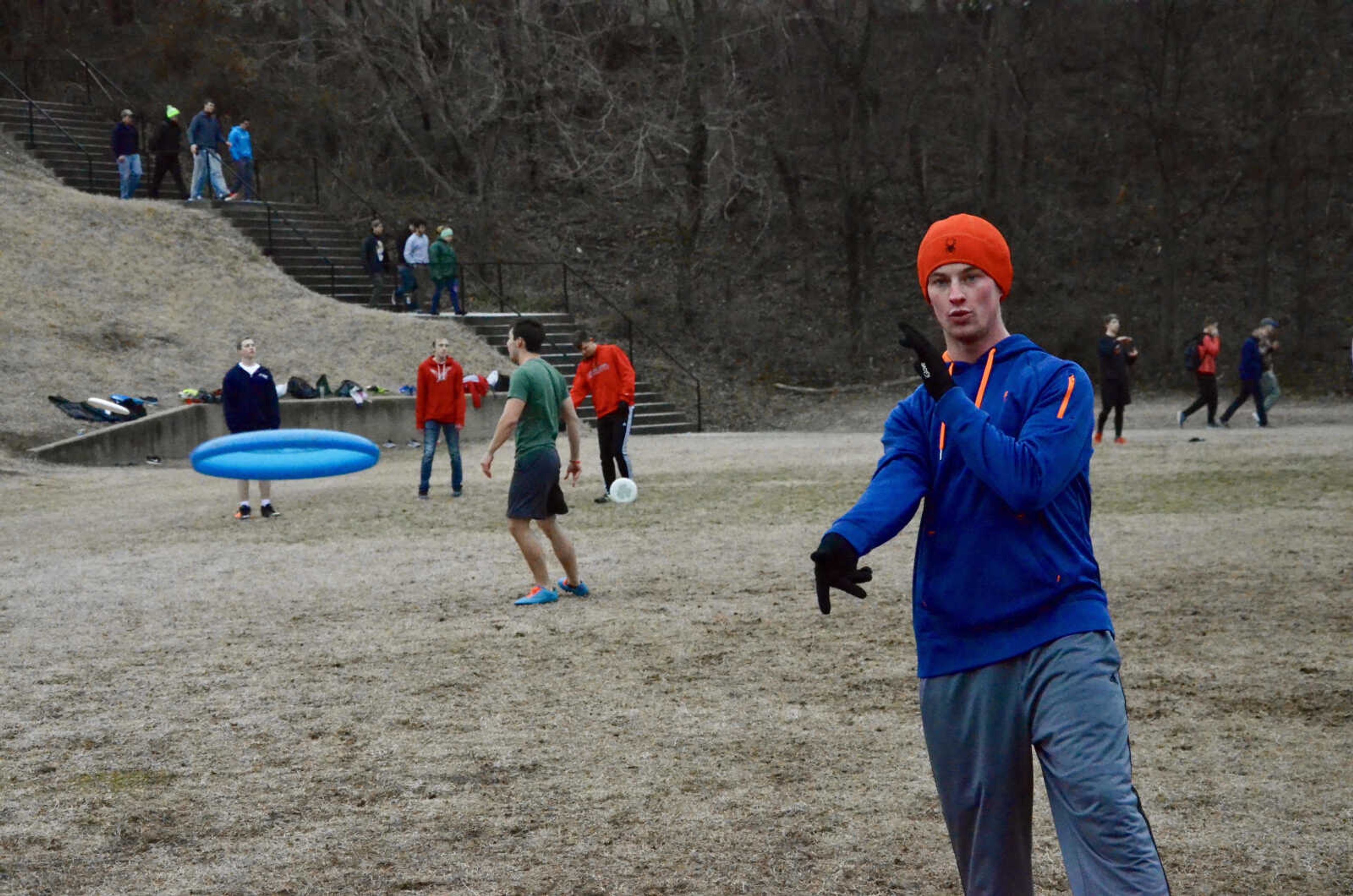 Ultimate frisbee president Connor McGough practices with his team on the old band practice field.