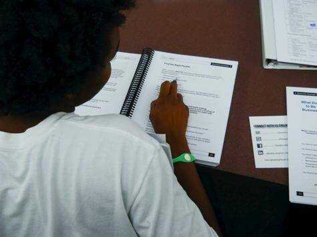 A student looks through a workbook while at the Operation JumpStart training program. Submitted photo