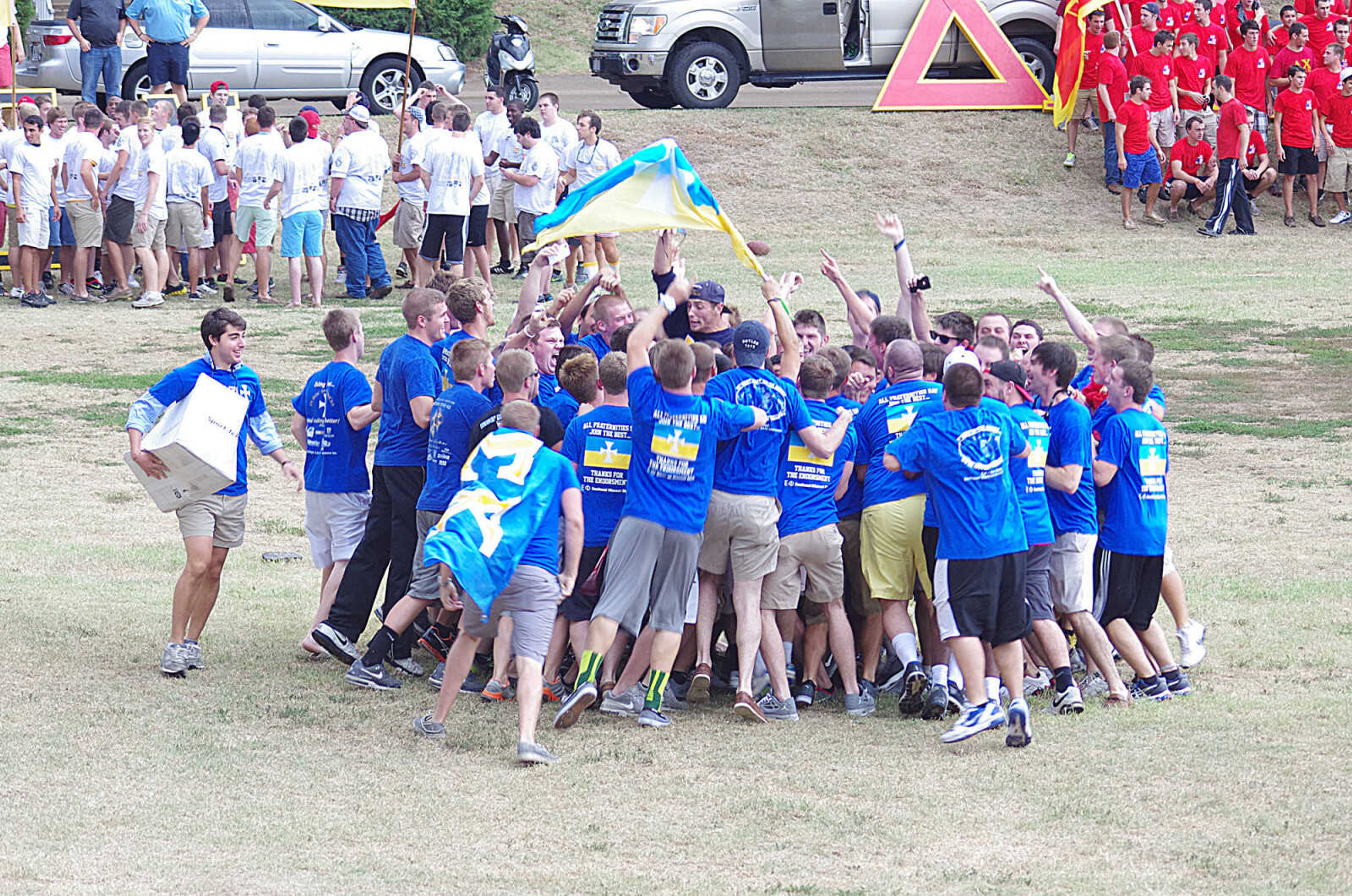 A fraternity jumps and cheers as they embrace their new brothers at Bid Day. Photo by Nathan Hamilton
