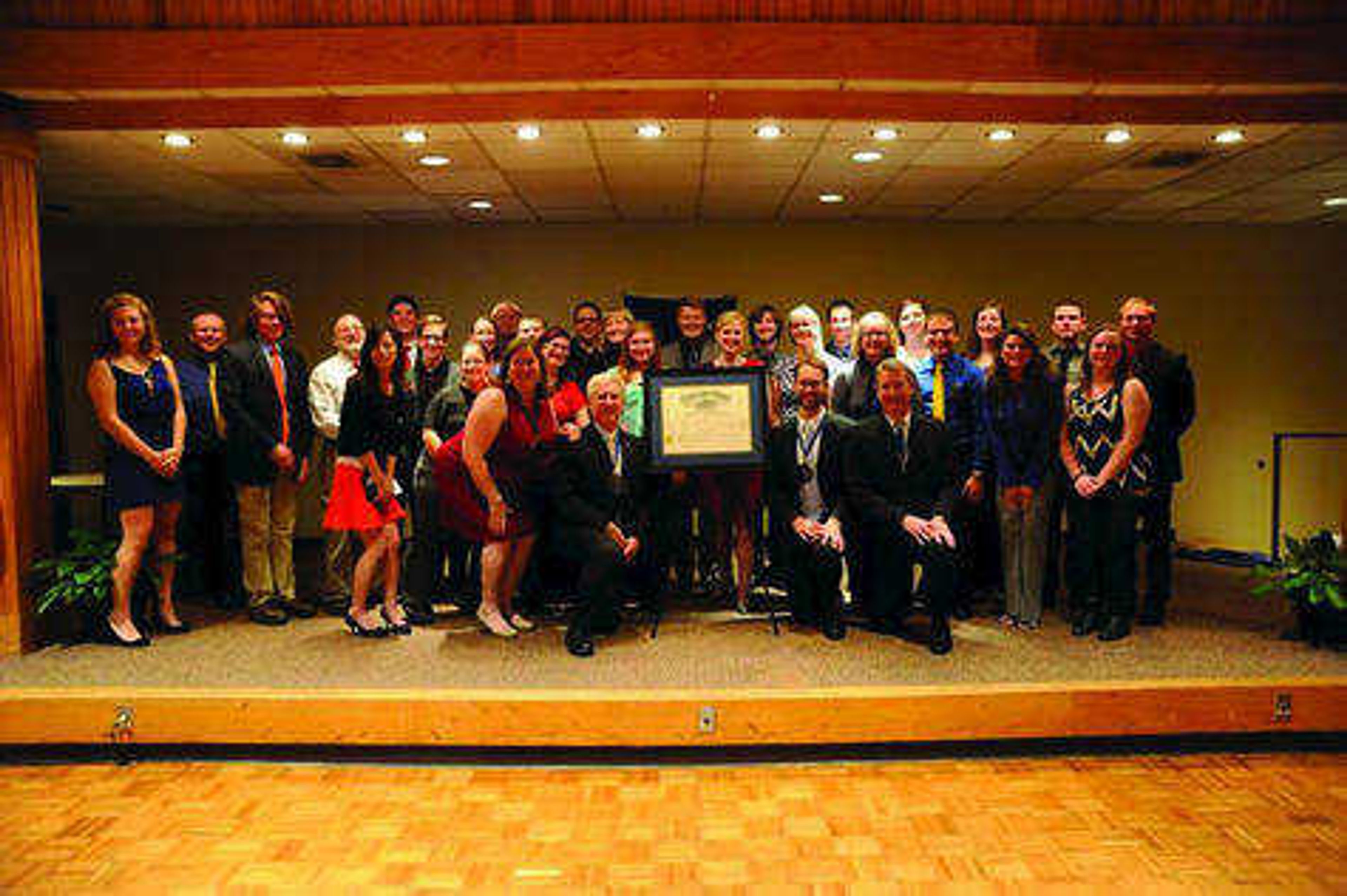 Members of Alpha Chi Sigma pose with their charter certificate in October. Submitted photo