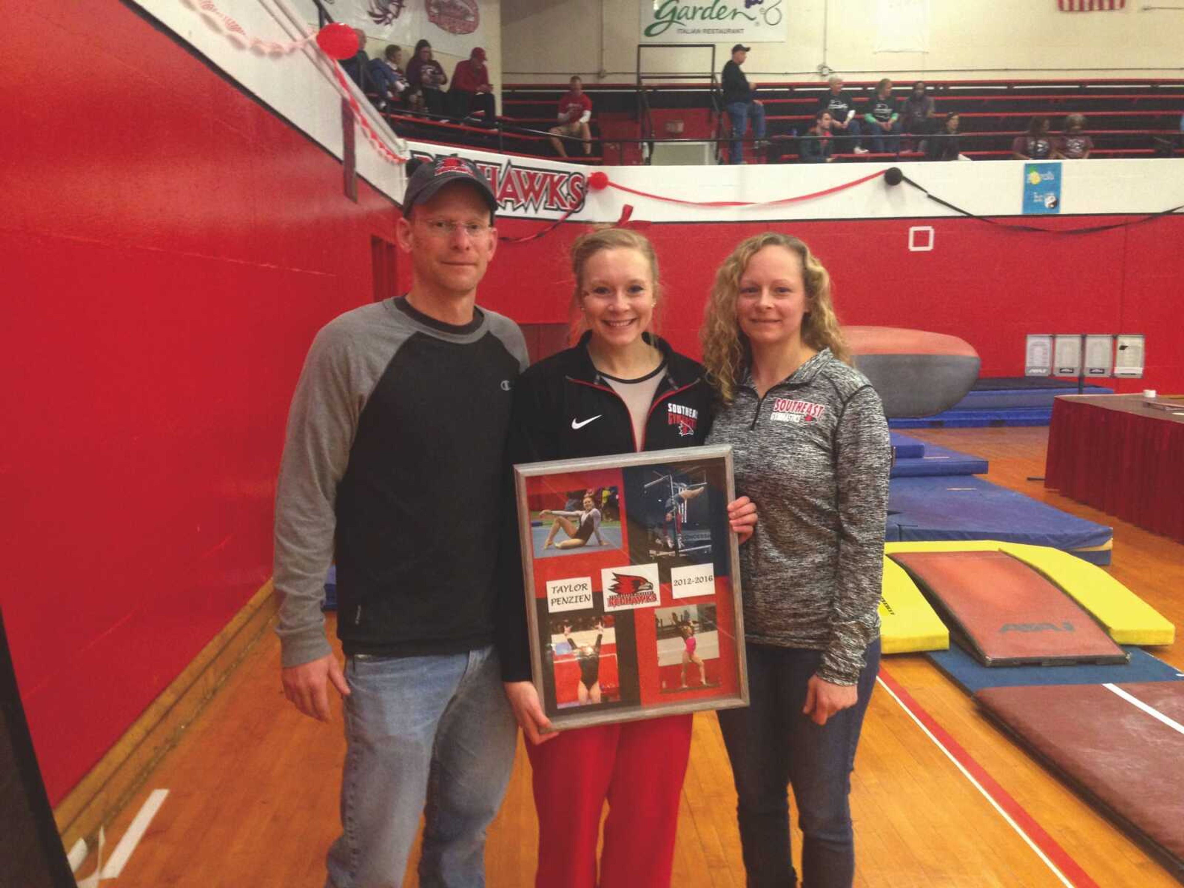 Senior gymnast Taylor Penzien is joined by her parents, Jim and Carrie, following her Senior Day meet.