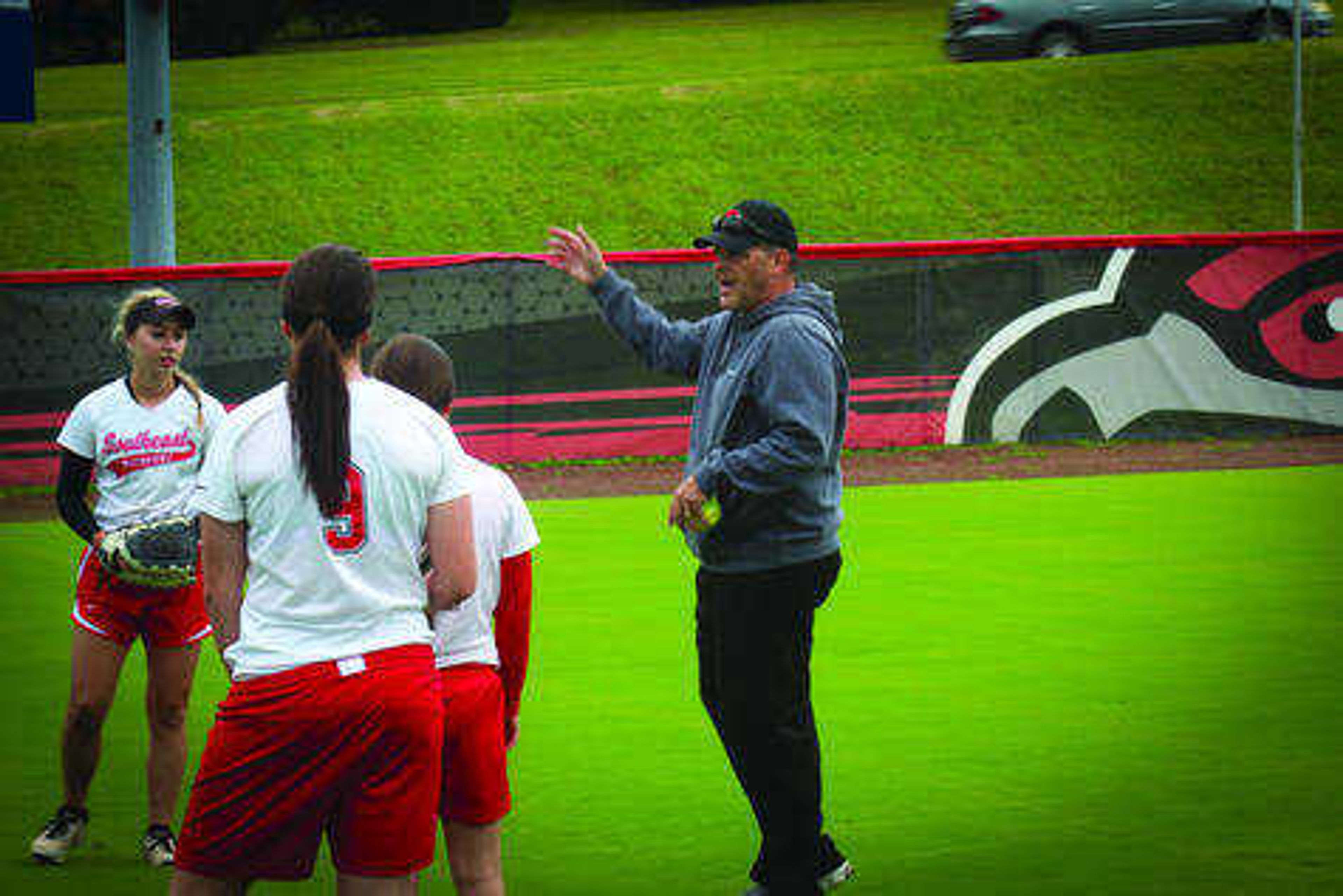First-year Southeast softball coach Mark Redburn instructs the team at Southeast Softball Complex. Photo by Sean Burke
