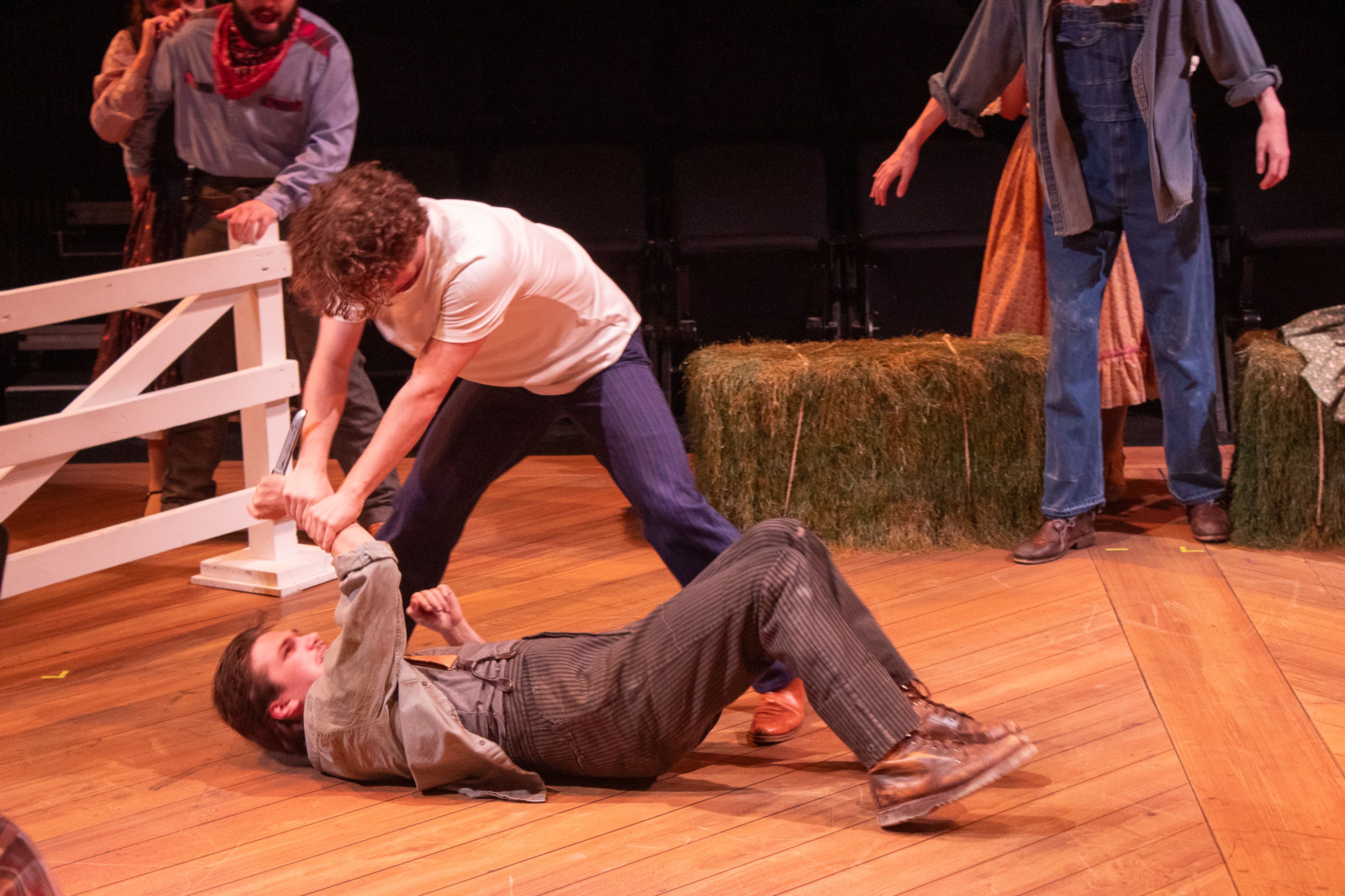 Jud, played by Luke Boucvalt, pulls a knife while he and Curly, played by Garrett Langley, fight.