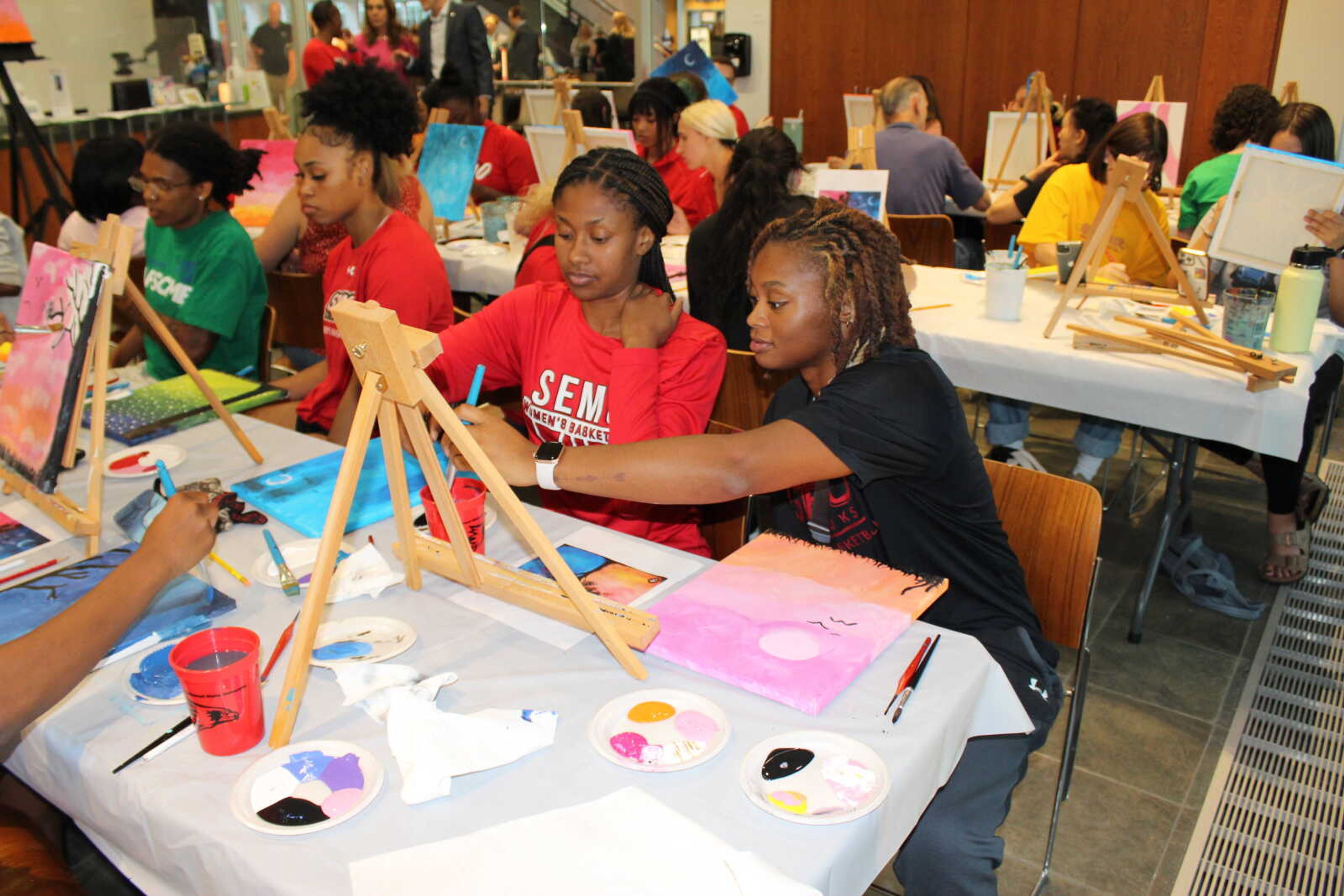 Sophomore health science major Alecia Doyle and senior multimedia journalism major Chandler Davis display their teamwork while painting at Crisp Museum. Both women are on the SEMO women’s basketball team. 