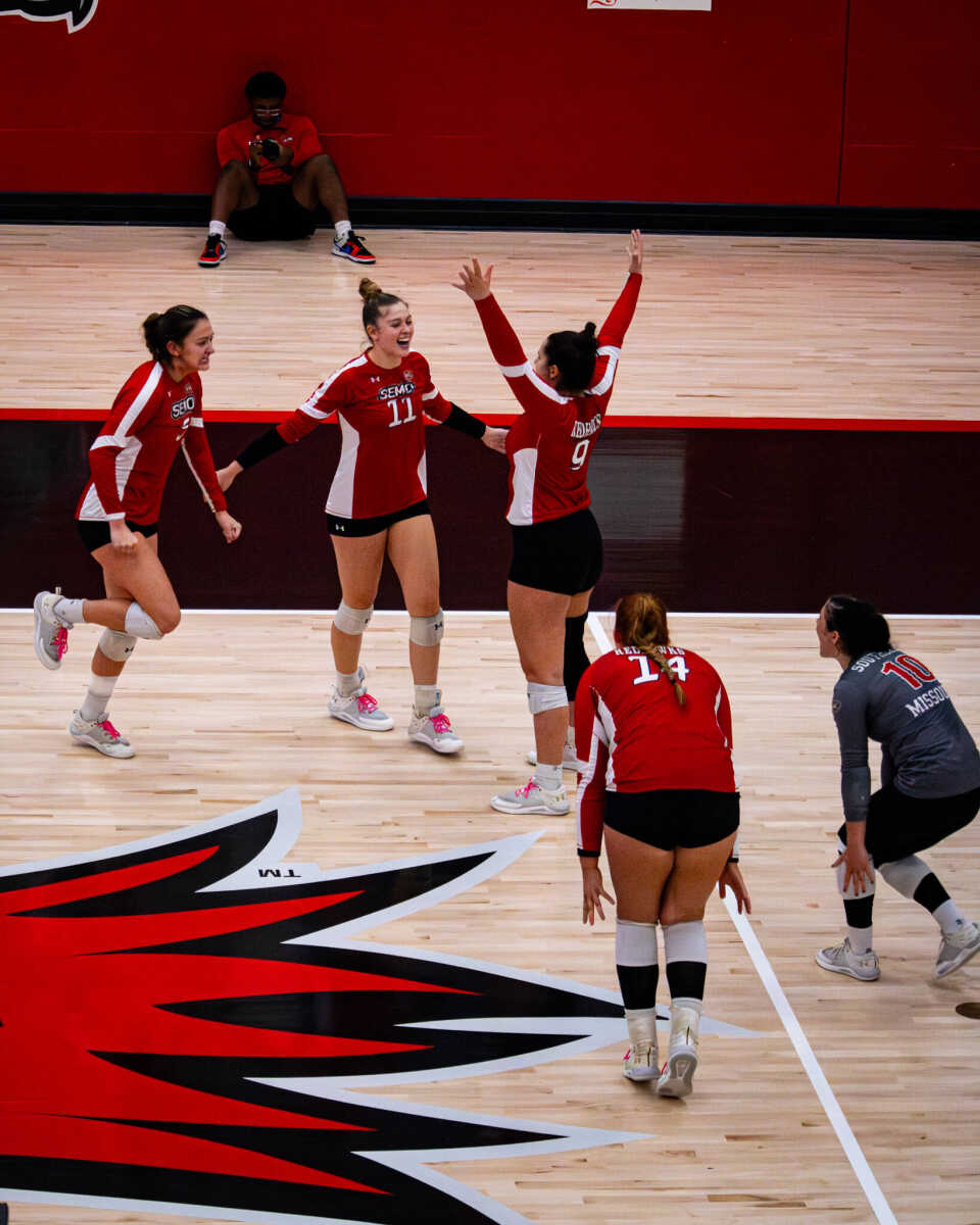 SEMO volleyball teammates celebrate together after scoring a point against the Lindenwood Lions.