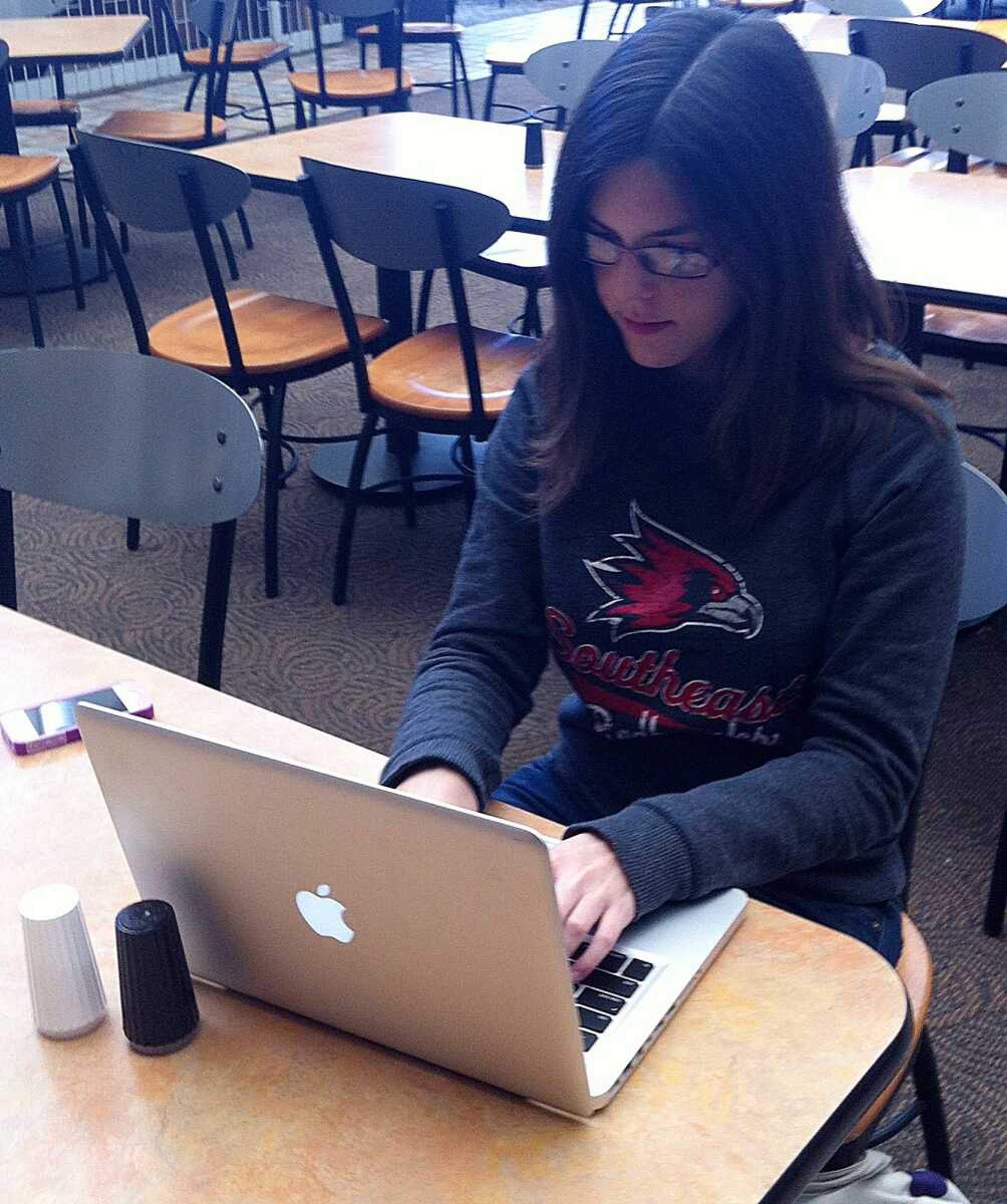 Annie Holzen works on her novel in the University Center. Photo by Jessica Bolhafner