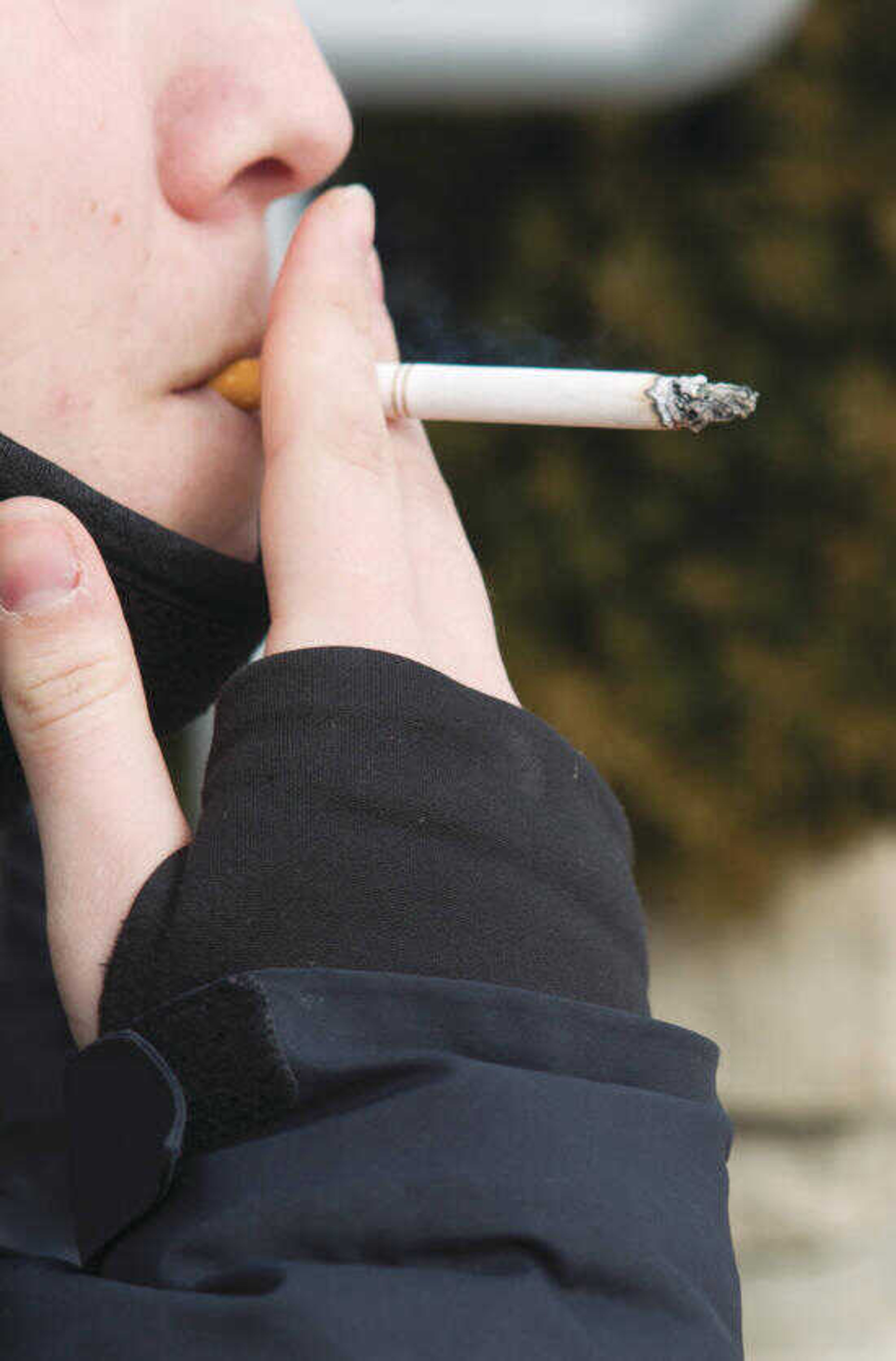 A student smokes outside of Grauel building.