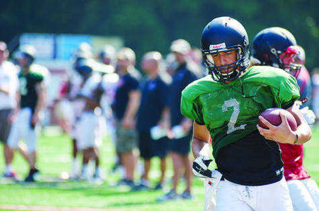 Tyler Peoples runs the ball during a scrimmage. Photo by Alyssa Brewer