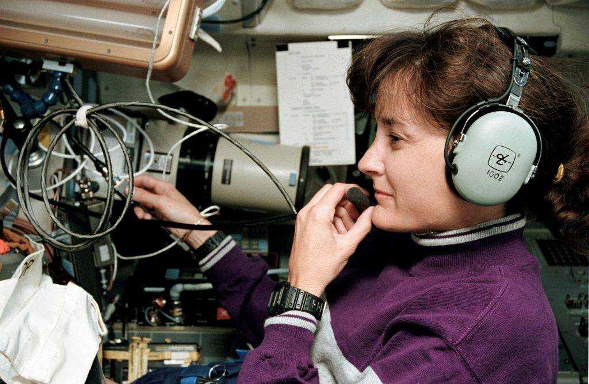 Linda Godwin as she uses Shuttle Amateur Radio Experiment, a radio that communicated with other amateur radios on Earth on space flight STS-59.