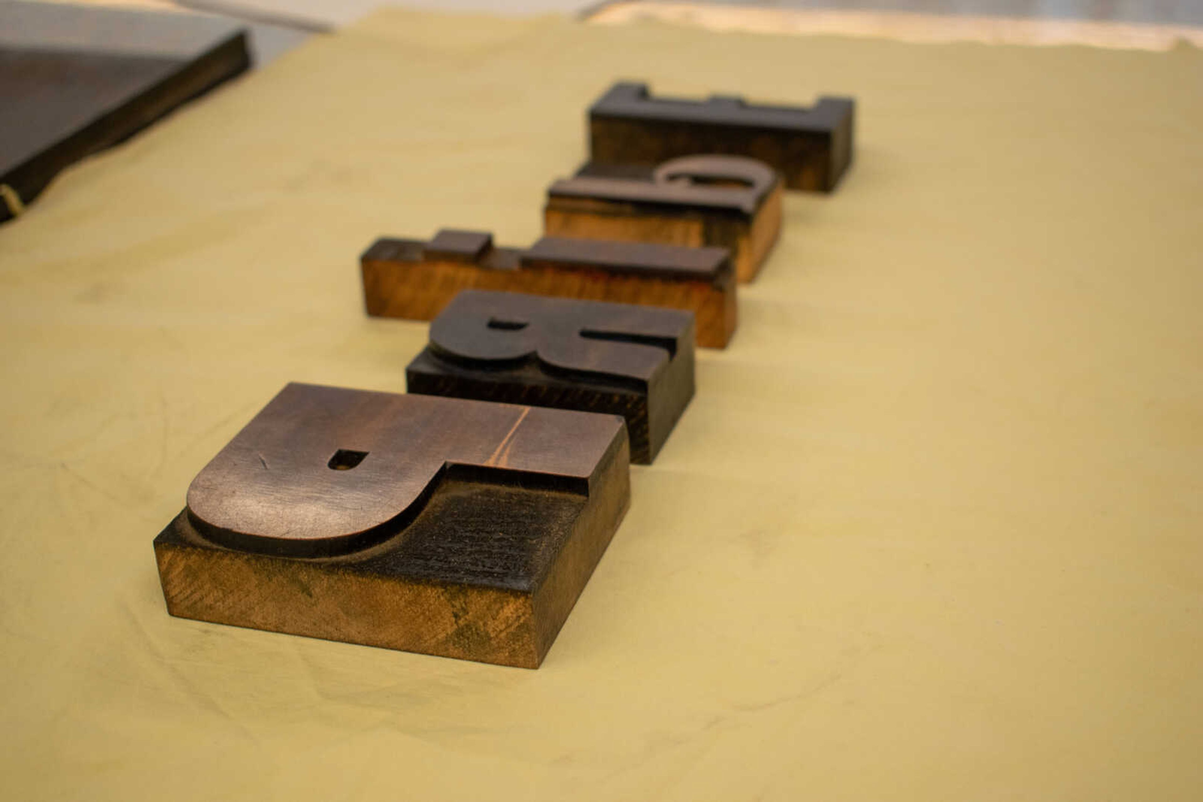 Students use blocks in printmaking to create protest banners on Saturday, Aug. 24 at Catapult.