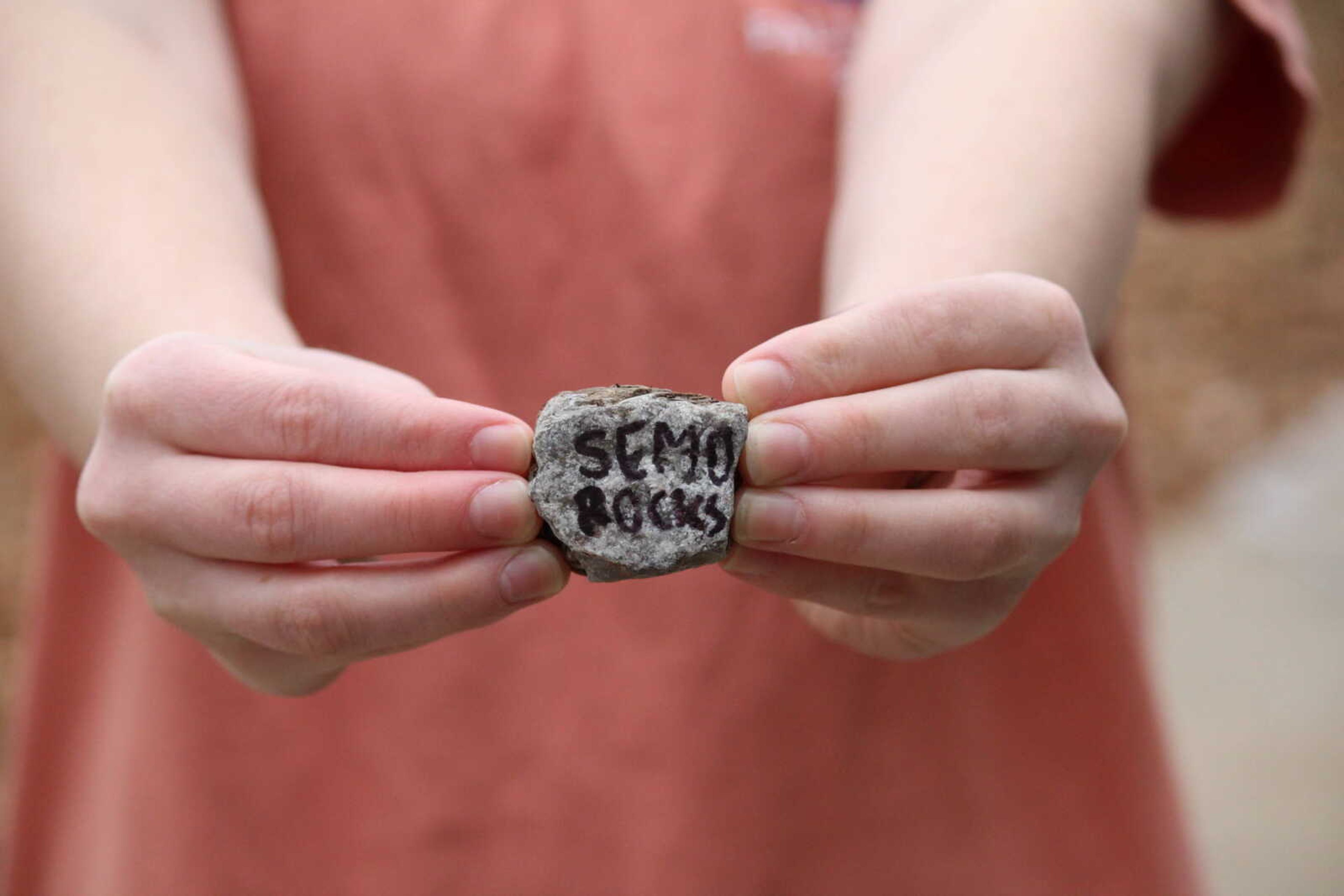 Southeast sophomore Mackenzie Ranchel holds a rock inscribed with the name of the group on Nov. 17.