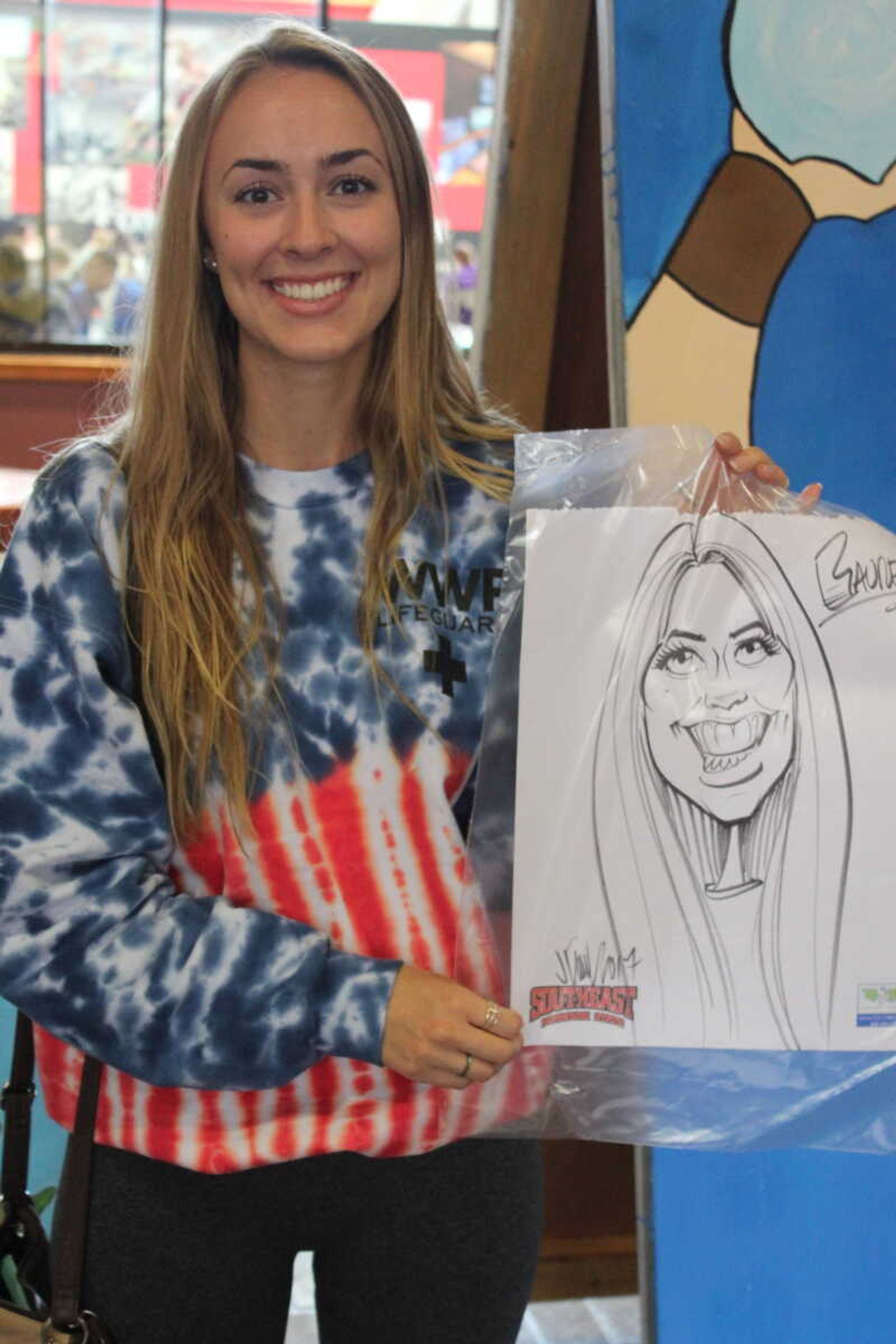 Lauren Grabow poses with her Caricature in the UC on Oct. 11.