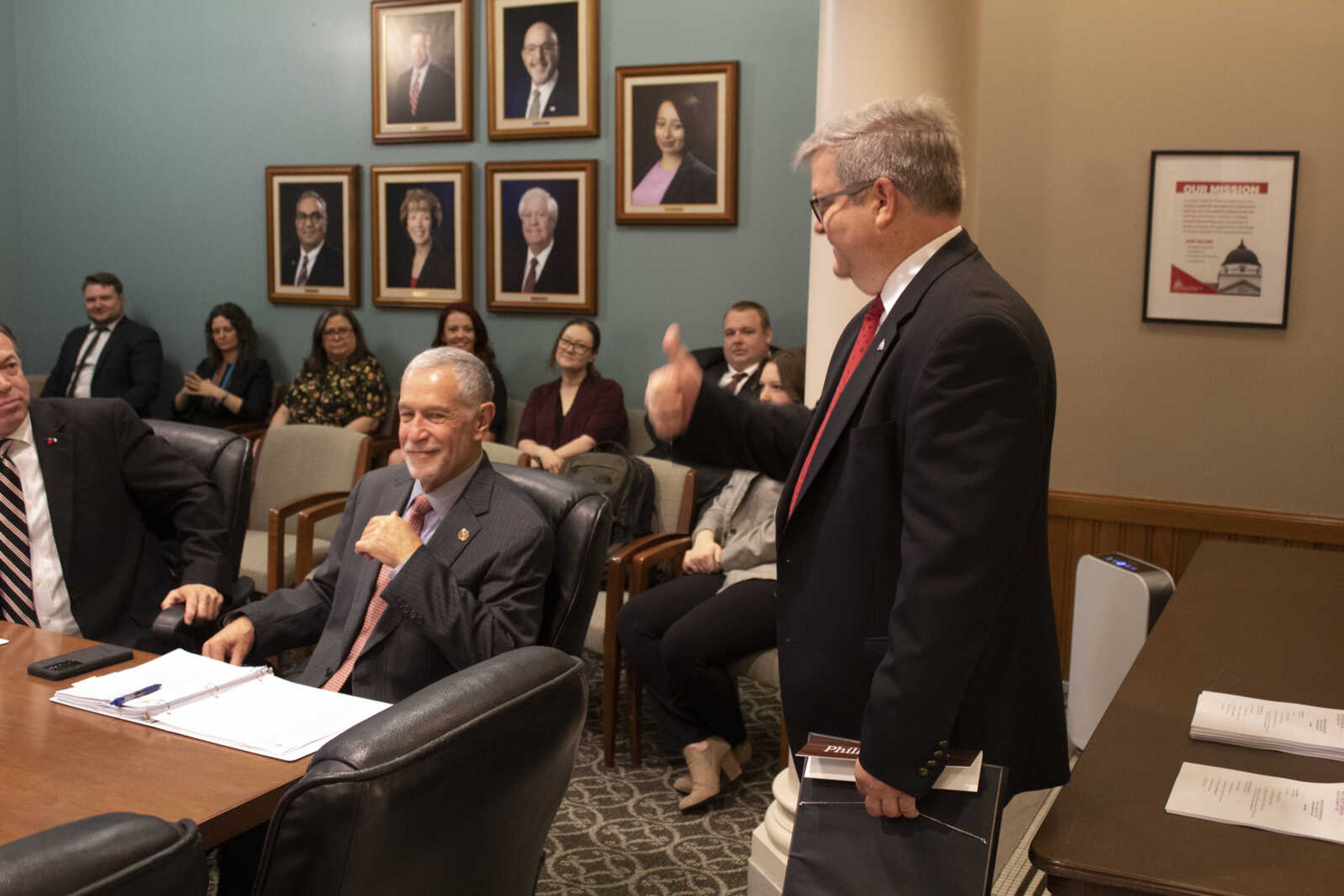 Former governor Phillip Britt walking off with his Resolution of Honor while giving the tumbs up to to the governors. Phillip Britt has been a part of the board since 2015.