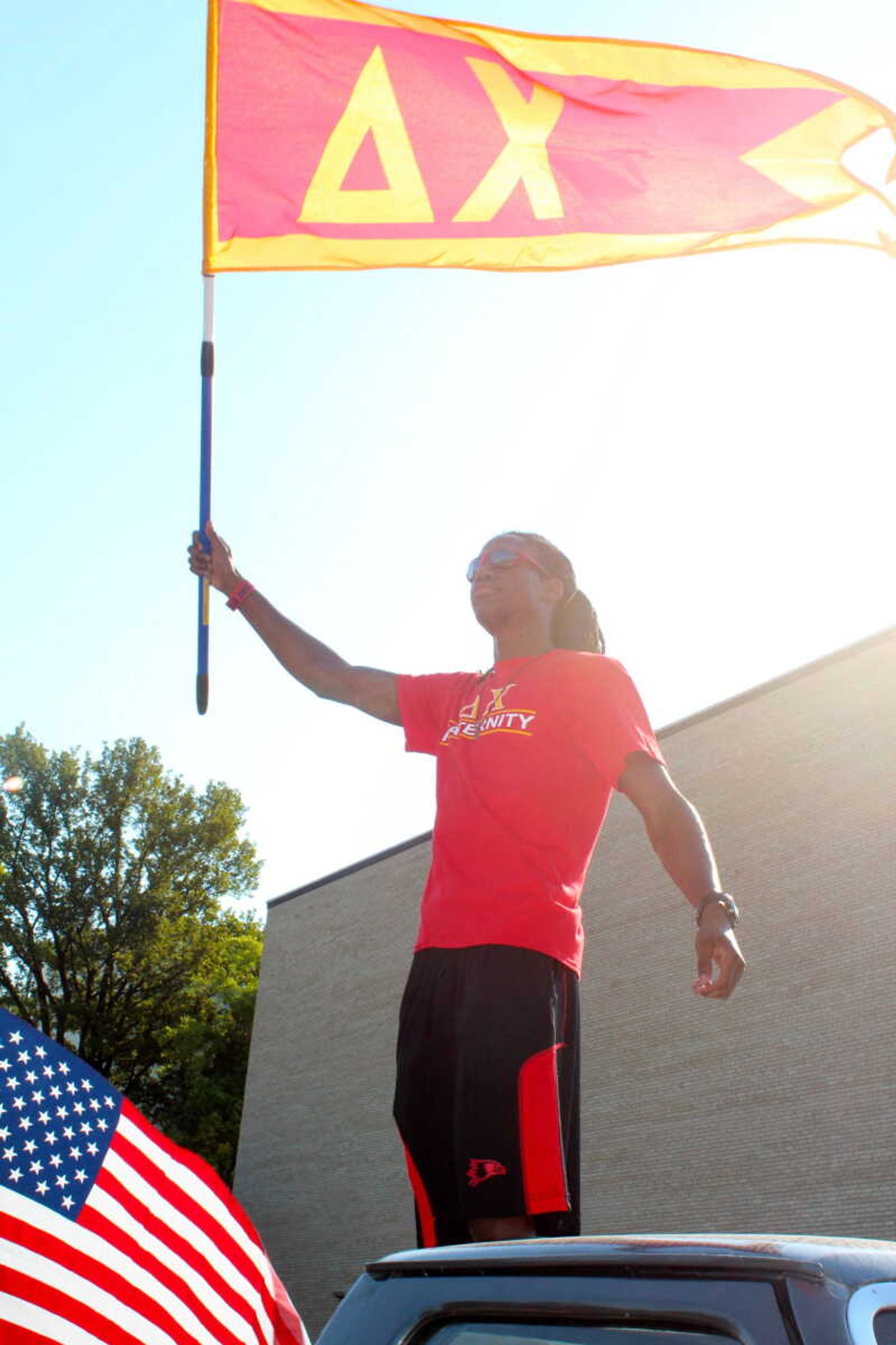  Delta Chi member holding his fraternity's flag.  Photo by Jami Black
