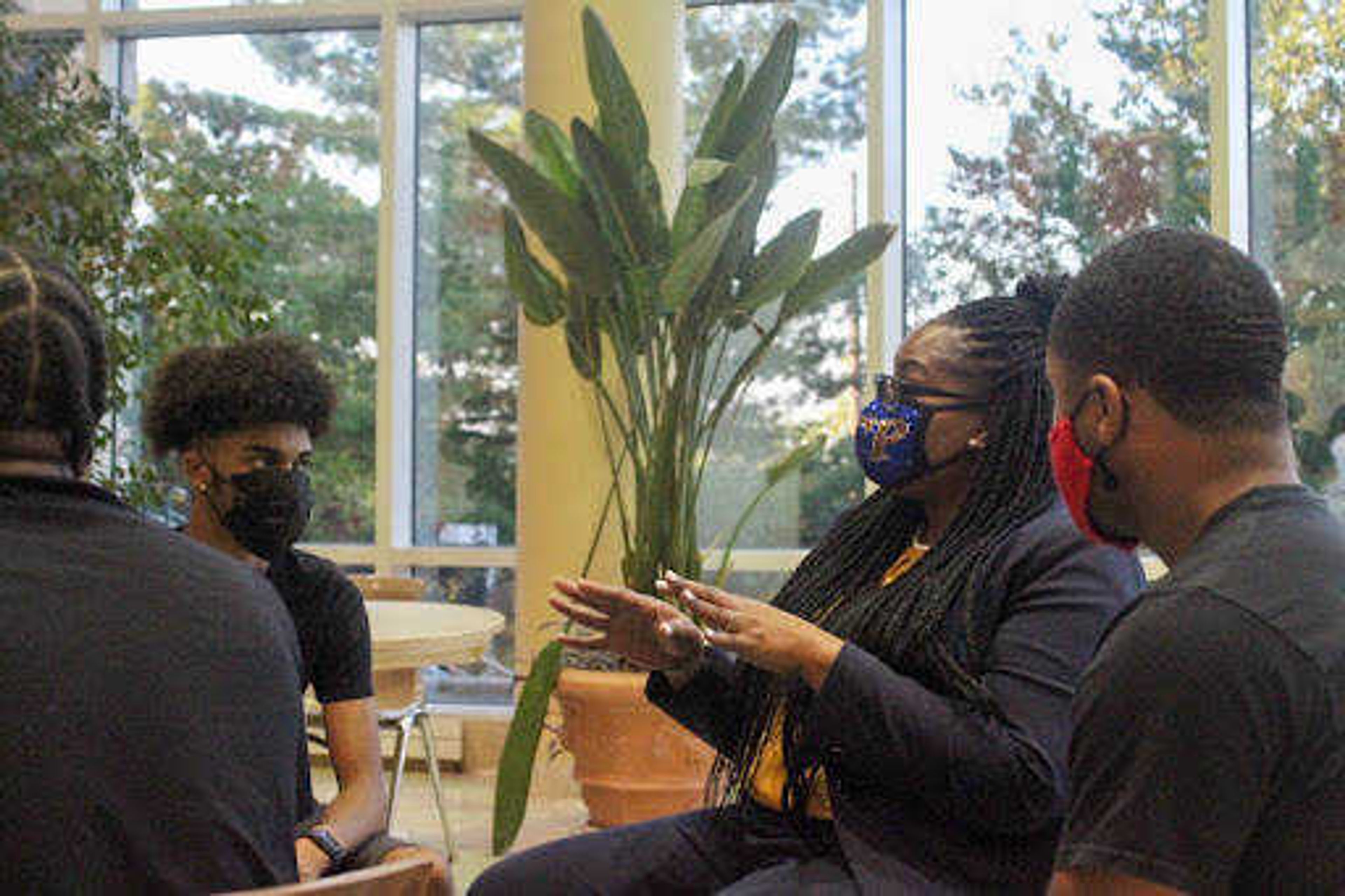 Director of Learning Assistance Programs WyKeshia Atkins advises freshman Ian Billiot (left) and sophomore Christen Griffin at the Black Faculty and Staff Meet and Greet. Billiot, who said he is an advocate for mental health, connected with a campus counselor at the event.