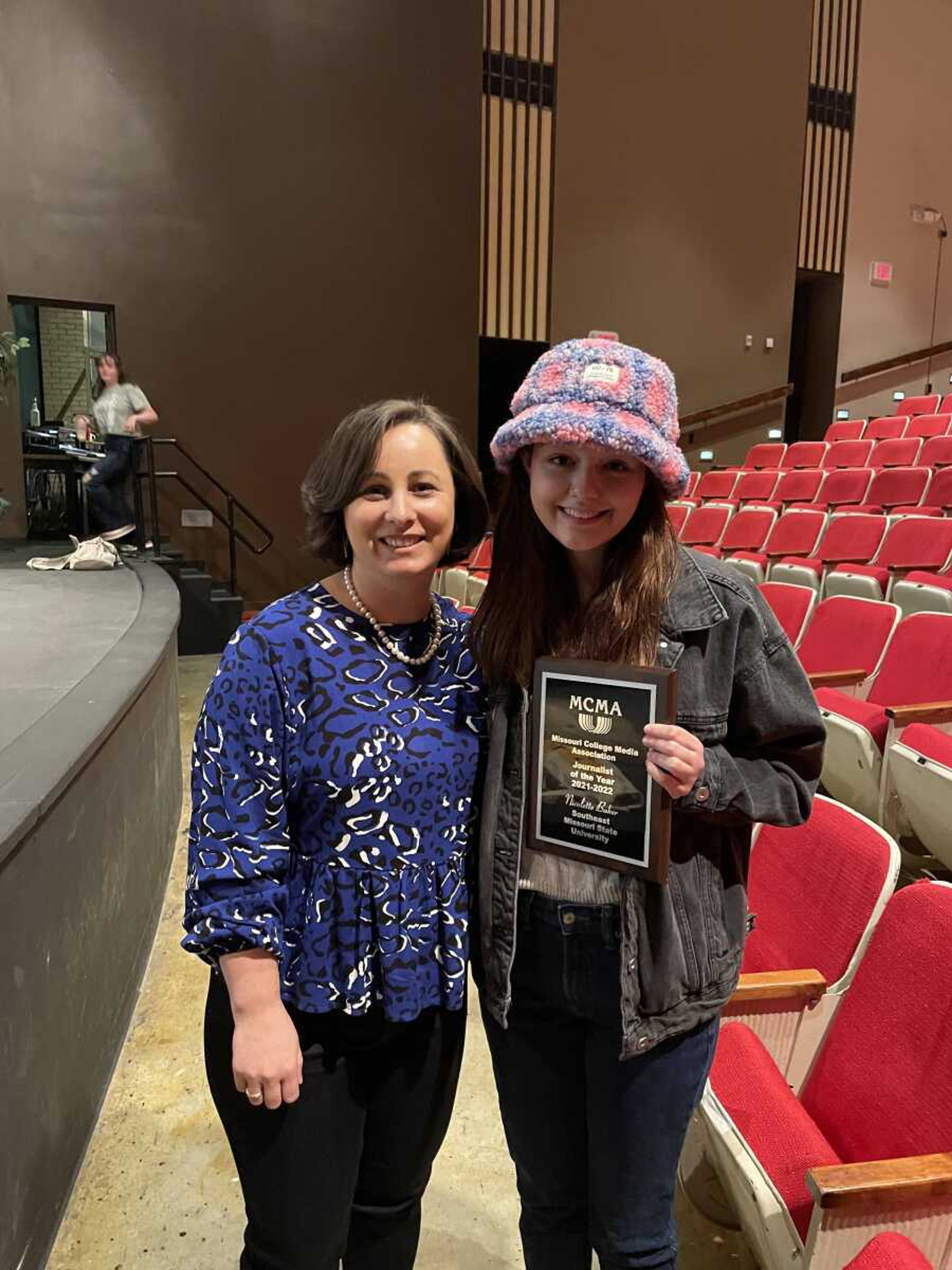 Arrow advisor Kate Stepaniuc (left) poses with features editor Nicolette Baker as she holds the Journalist of the Year award. Baker revived the award during the Missouri College Media Association Conference on April 9.