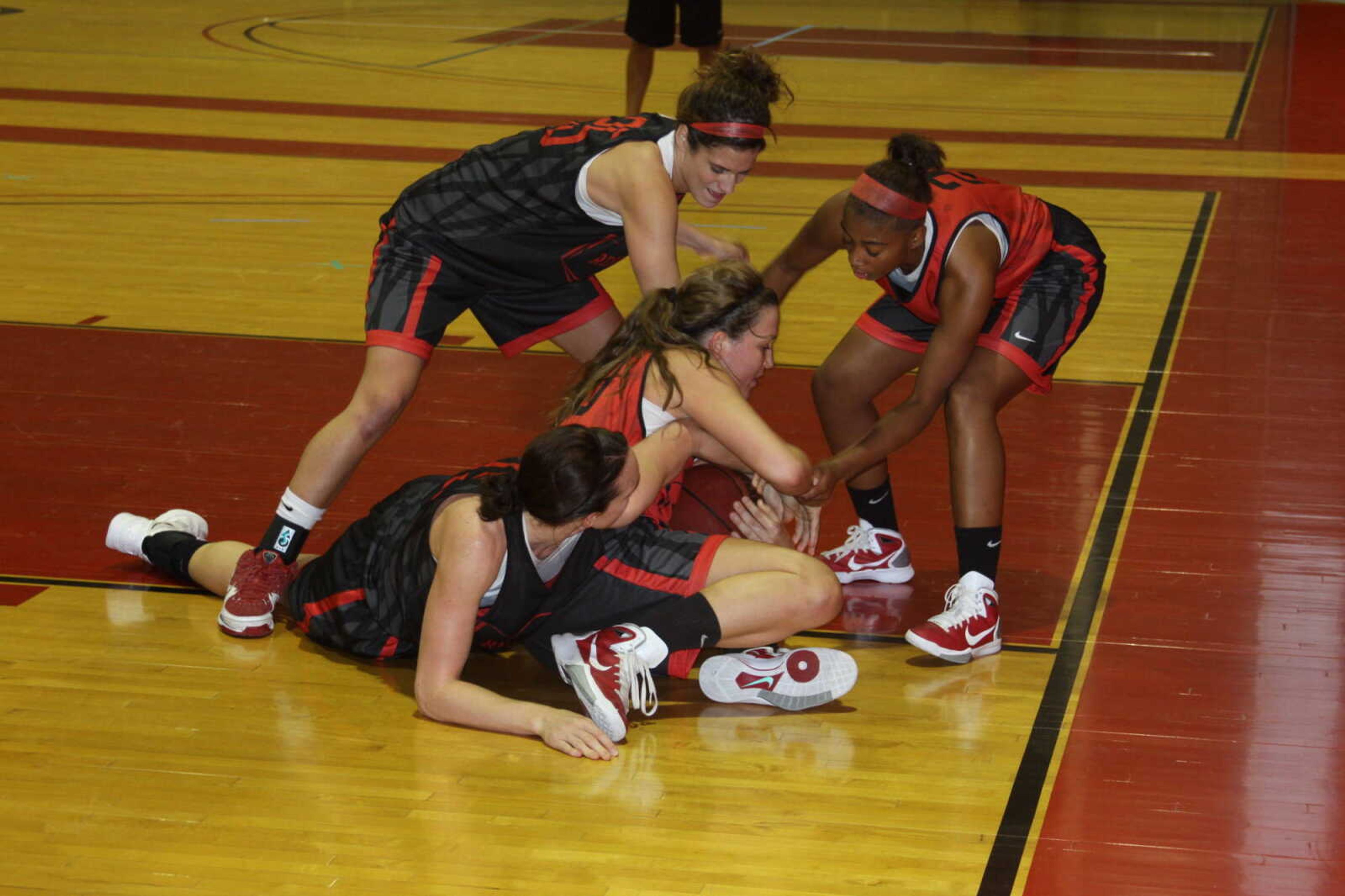 (Clockwise from top) Katie Norman, Yelena Rosado, Bailie Roberts and Brittany Harriel fight for possession of the basketball during the team's practice on Oct. 21. - Photo by Kelso Hope