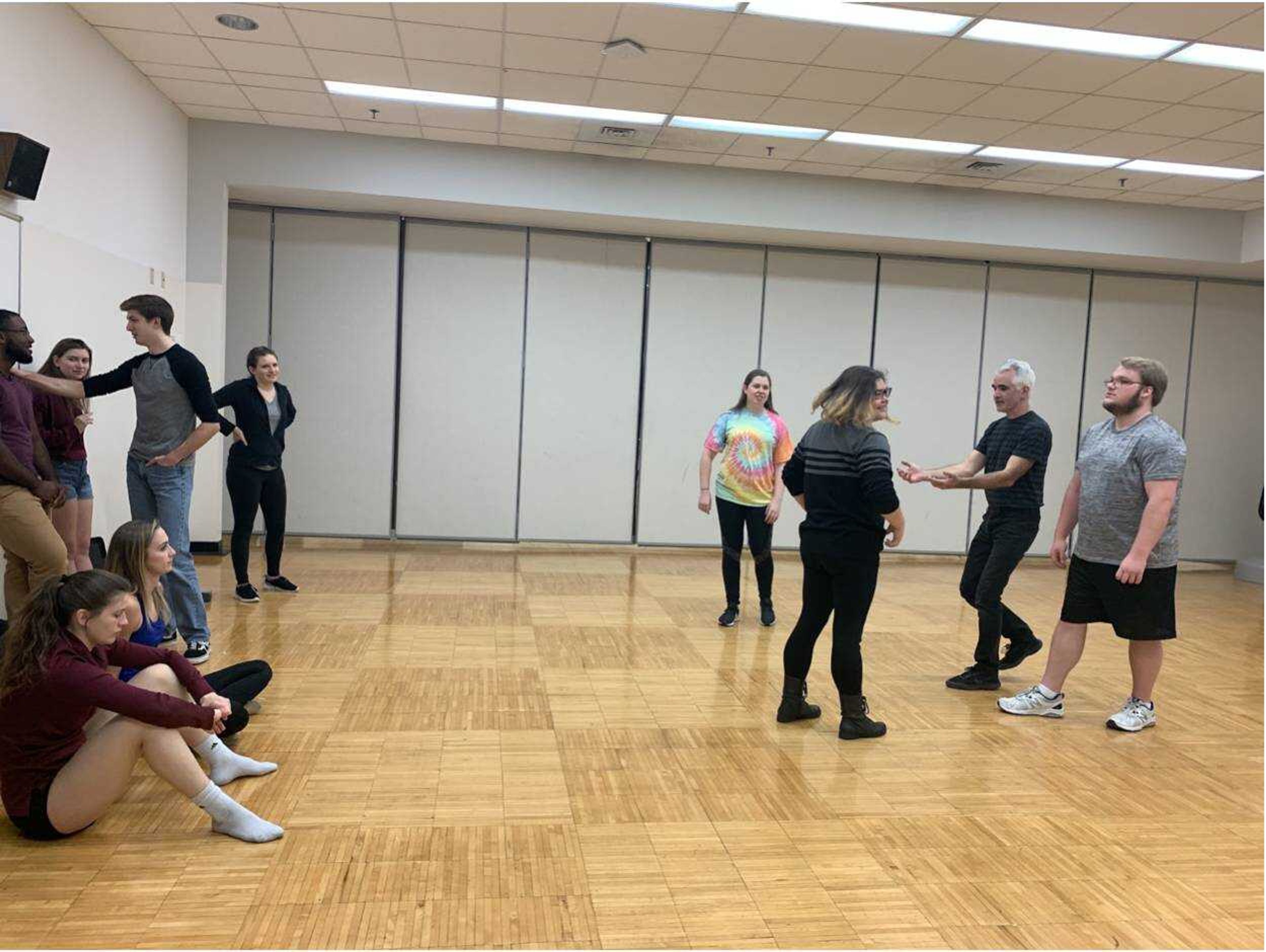 Instructor Shawn McNally holds his arms out, demonstrating steps to a dance technique on Nov. 10, 2019 during a club rehearsal.