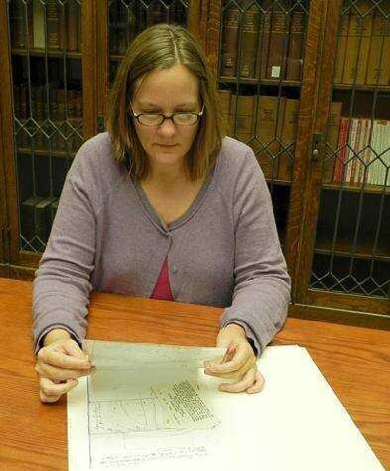 Project Manager Ellen Ryan looks over a map from the Civil War Collection. Photo by Kelsey Barksdale