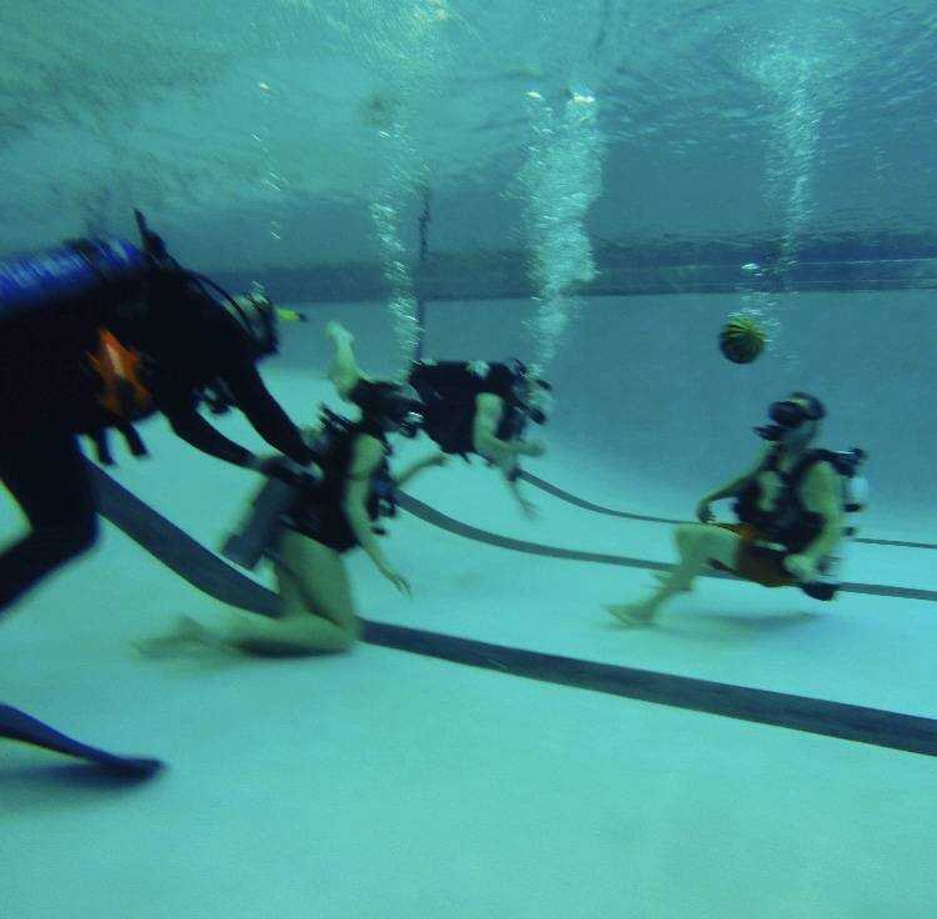 Amanda Milbrandt and Tori Wright taking part in games while scuba diving at the Student Aquatic Center.