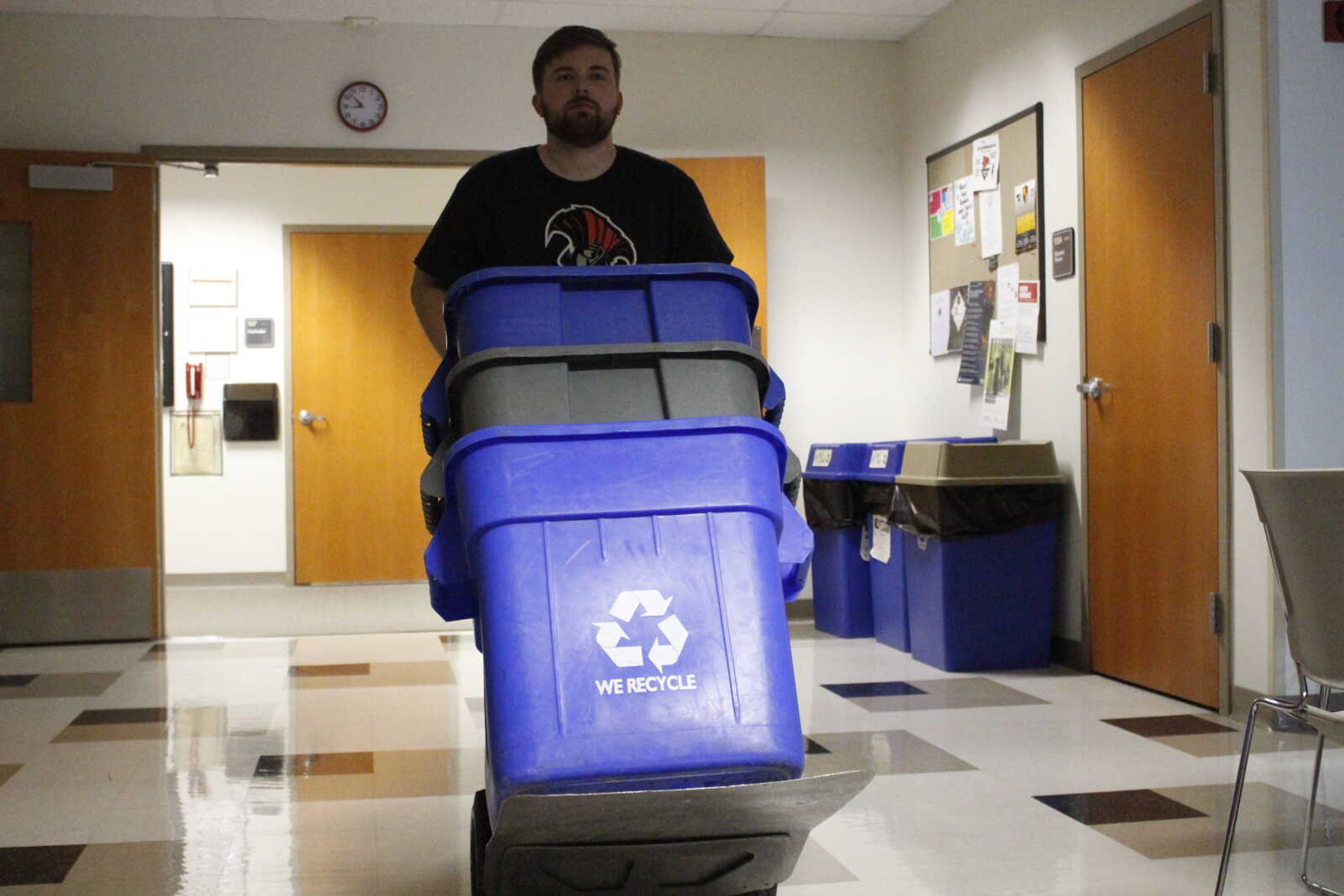 Southeast senior James Grosch replaces recycling bins at Carnahan Hall Aug. 27.
