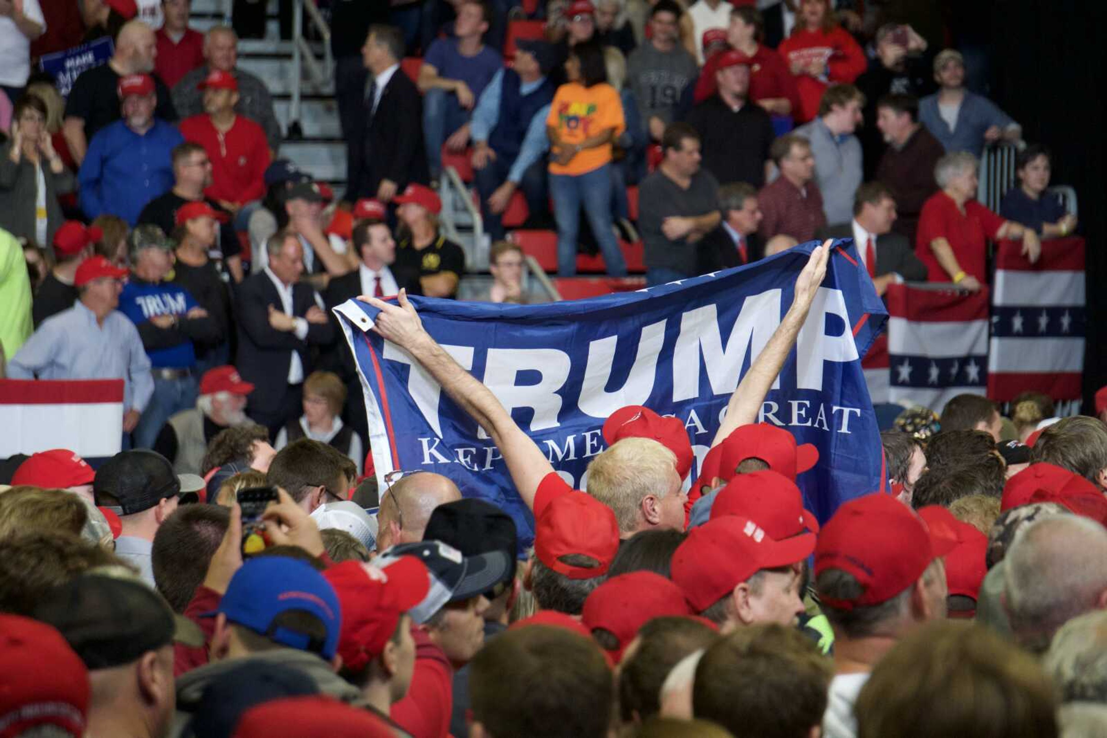 Signs distributed by Donald J. Trump for President, Inc. are held up by the crowd at President Trump's last MAGA rally of the Midterm Elections in Cape Girardeau Nov. 5.