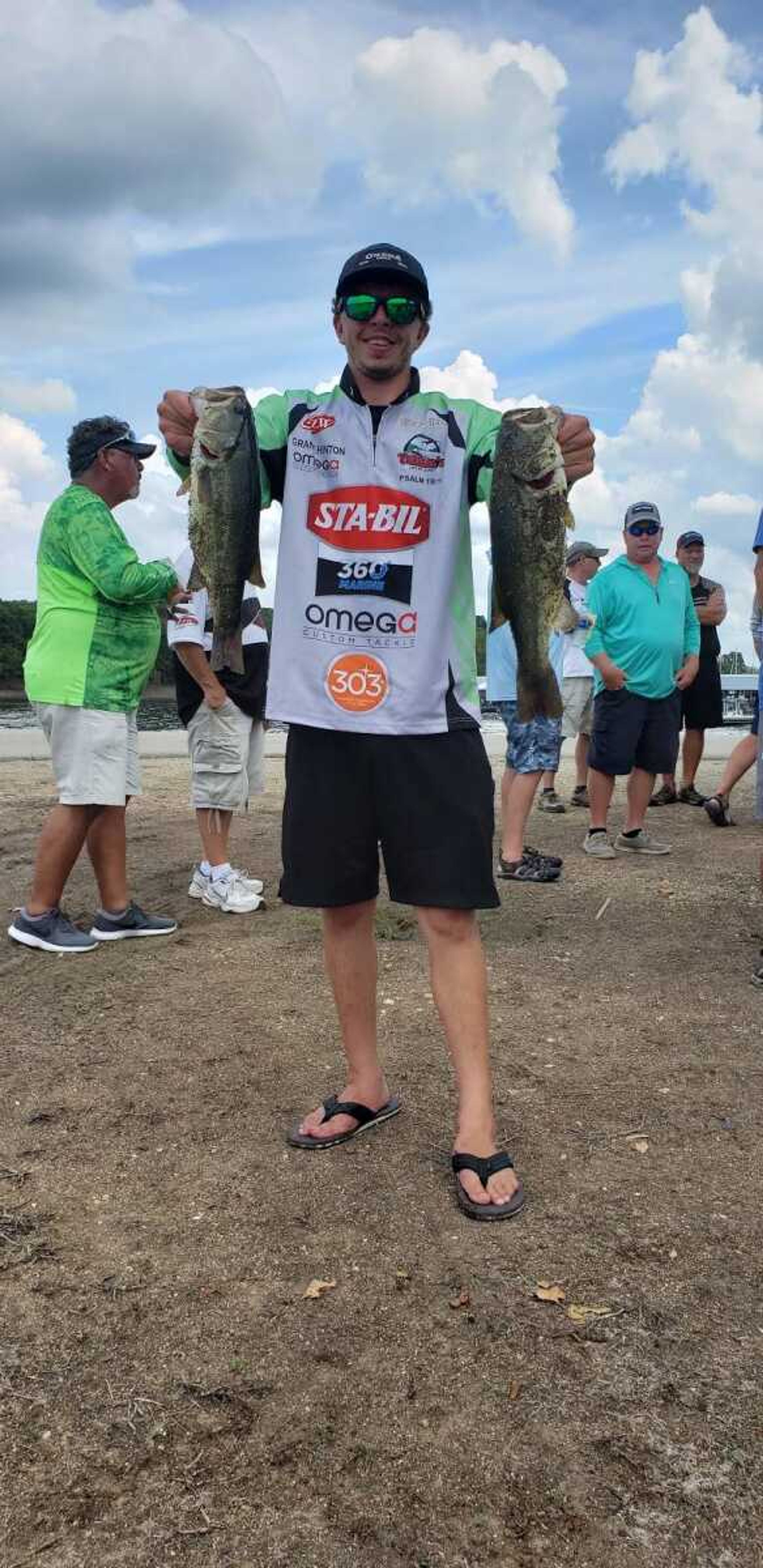 Grant Hinton poses with two bass after a competition at Truman Lake in Warsaw, MO in August 2018.