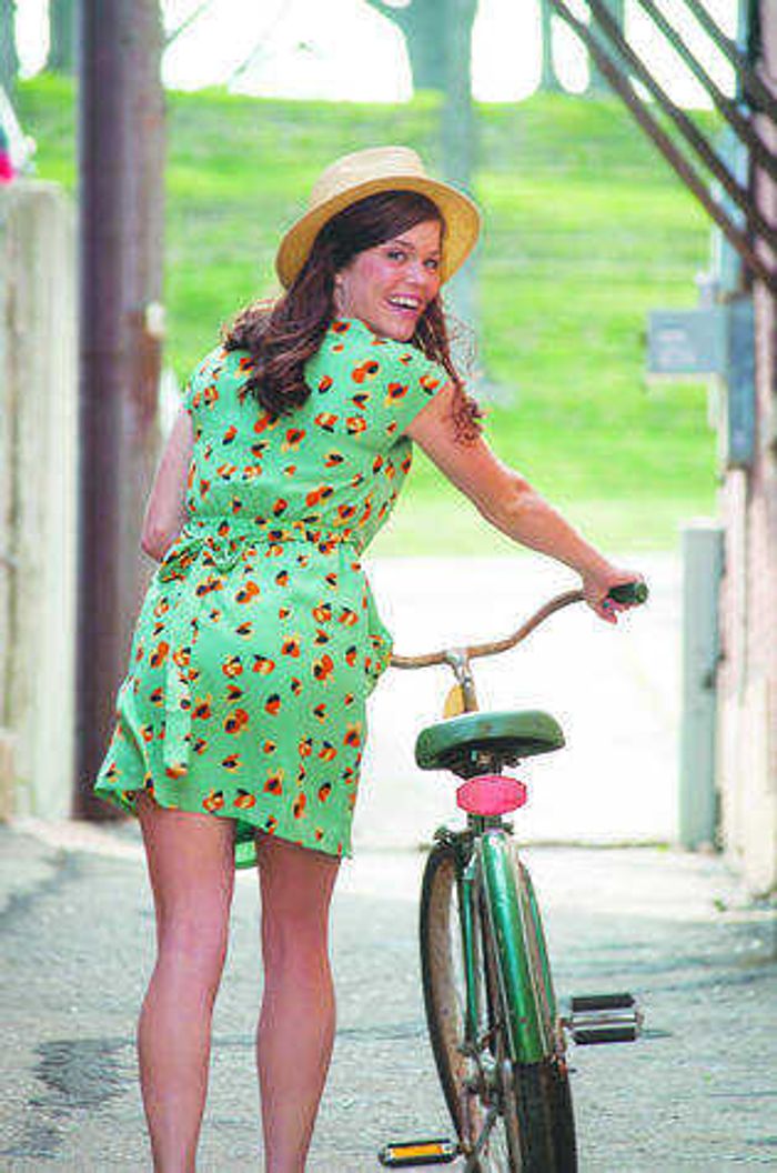 Green print dress and straw hat from Stash. Vintage bicycle from Judith's Antiques. Photo by Alyssa Brewer