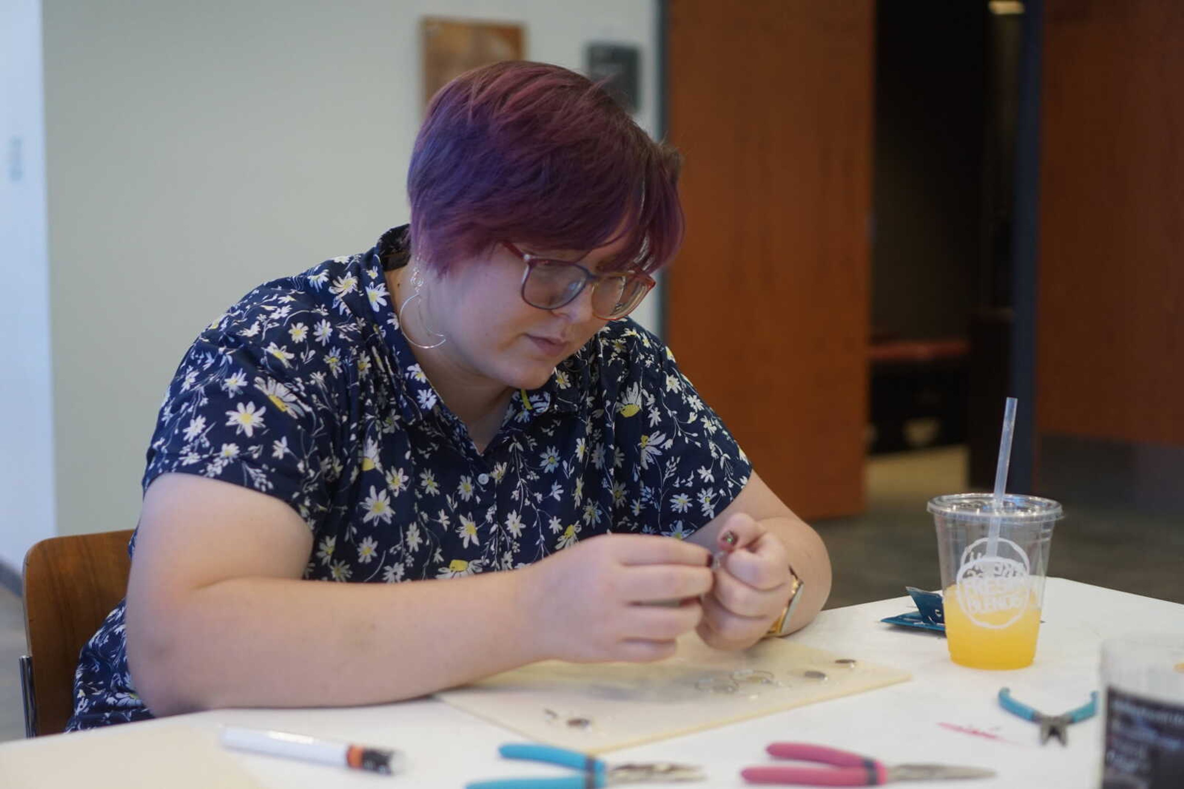 Senior art major Rebecca Byington works on her third pair of earrings.