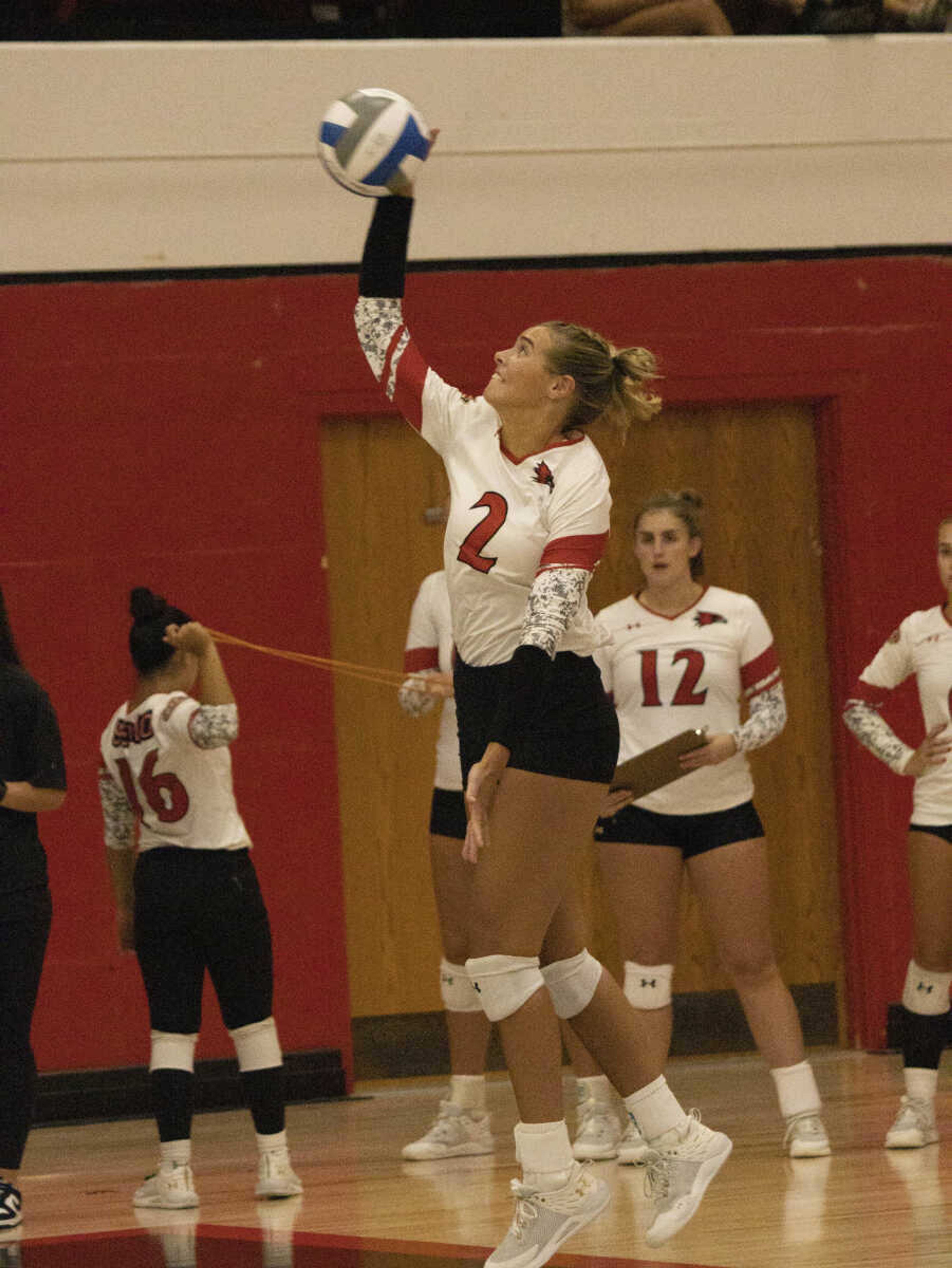 Lucy Arndt goes to serve the volleyball over the net for a point for the Redhawks on Aug. 25.