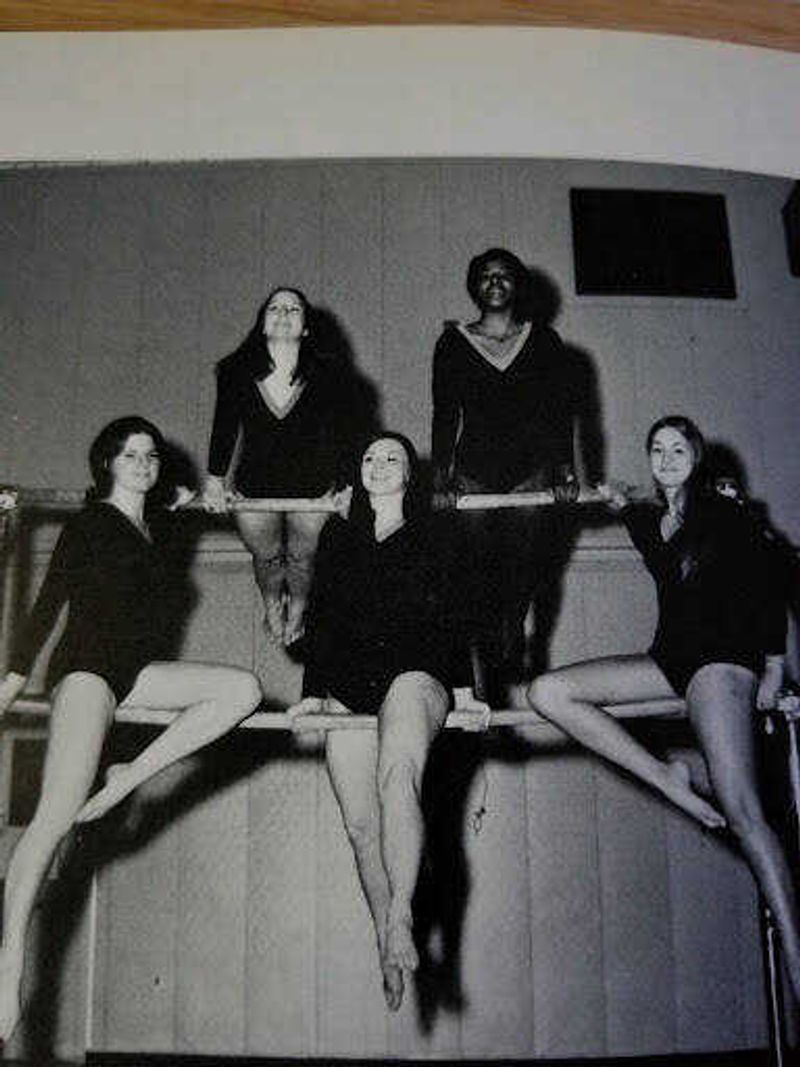 Linda Webb (top right) poses with gymnastics teammates in high school.