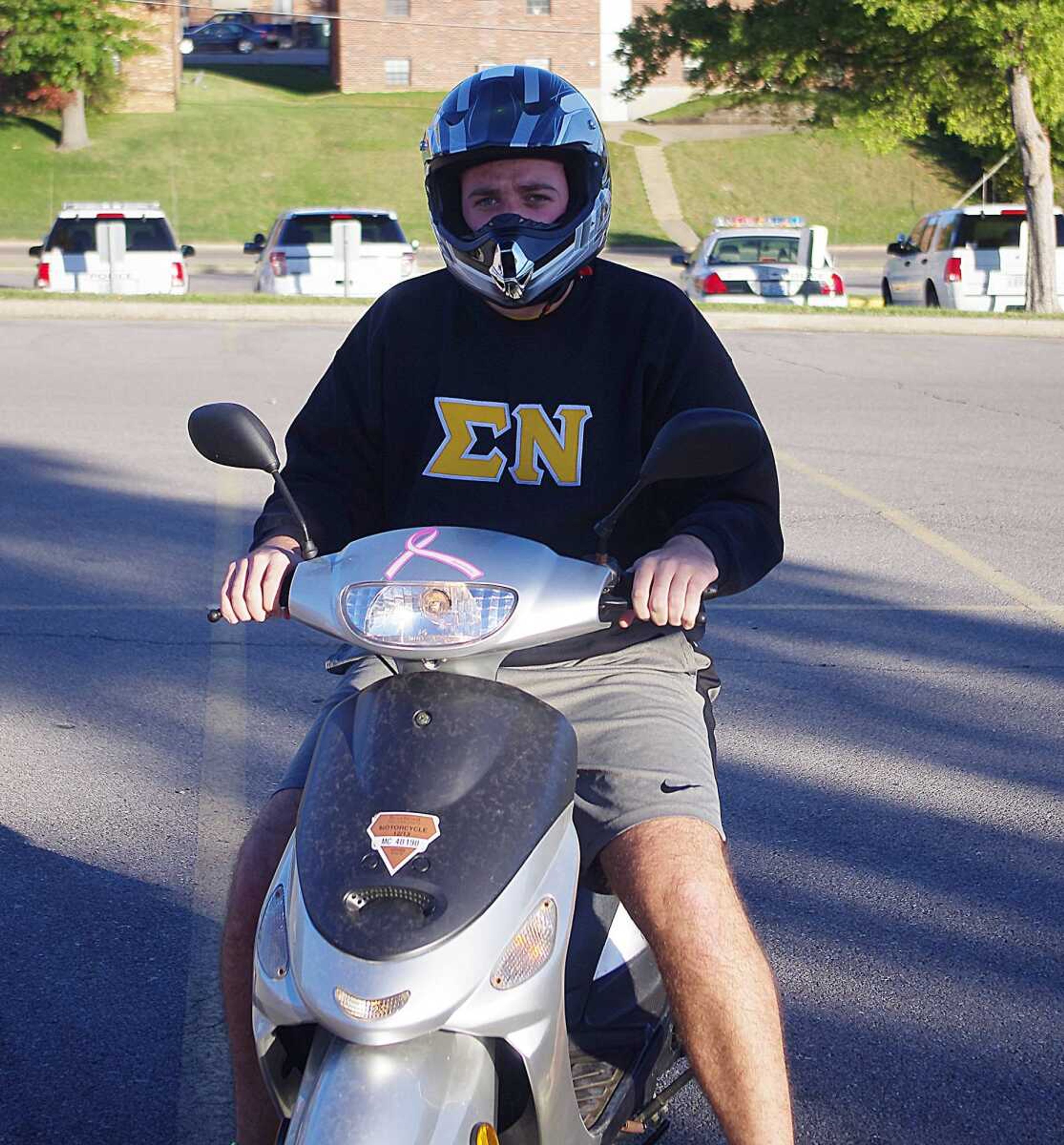 Jason Billmeyer wears a helmet while riding his scooter Monday on campus. Photo by Nathan Hamilton