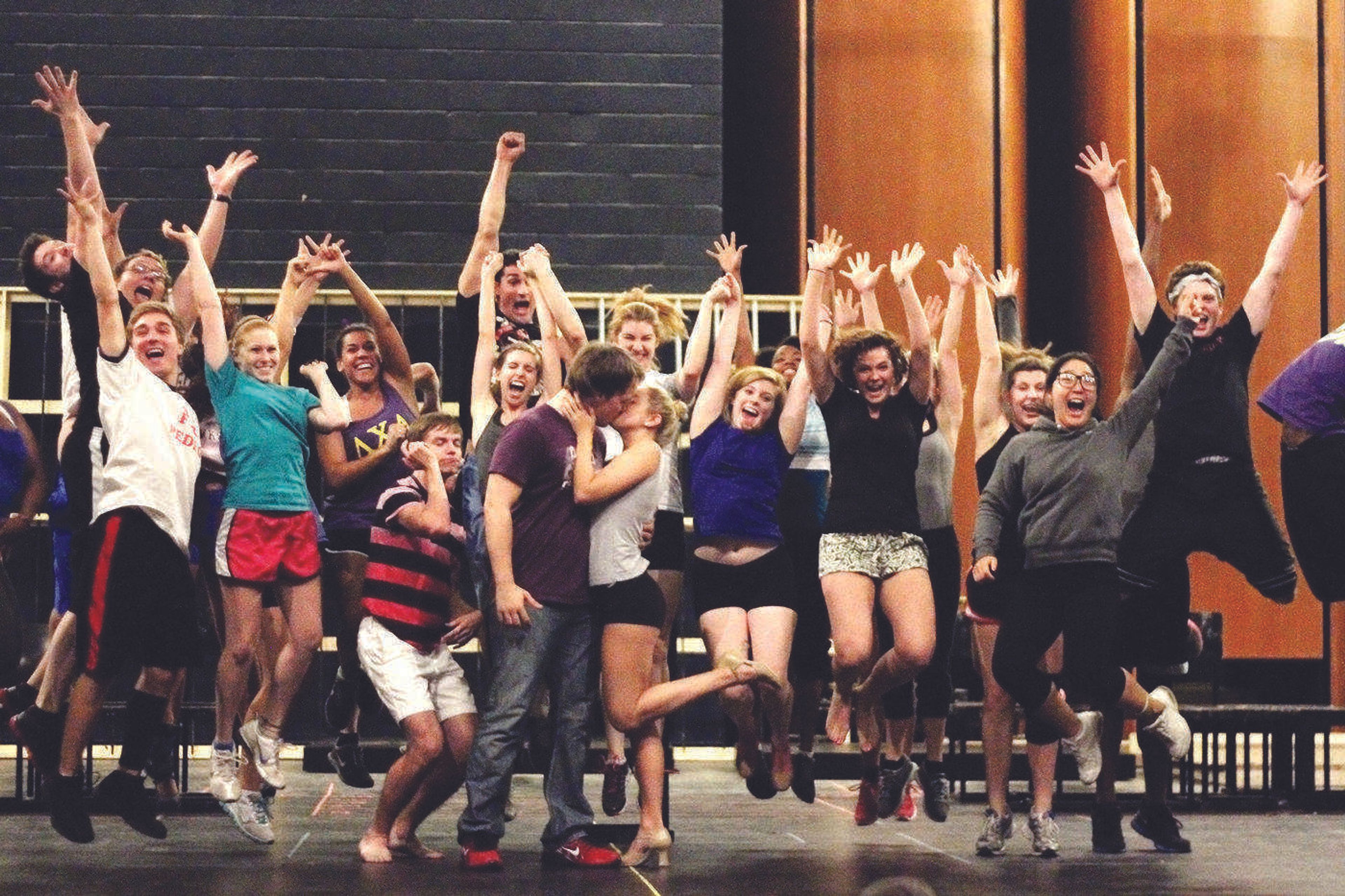 <b> Molly Dowd and Jacob Buckenmeyer embrace during rehearsals of "Legally Blonde" as the rest of the cast watches.</b> Photo by Brittany Thomsen