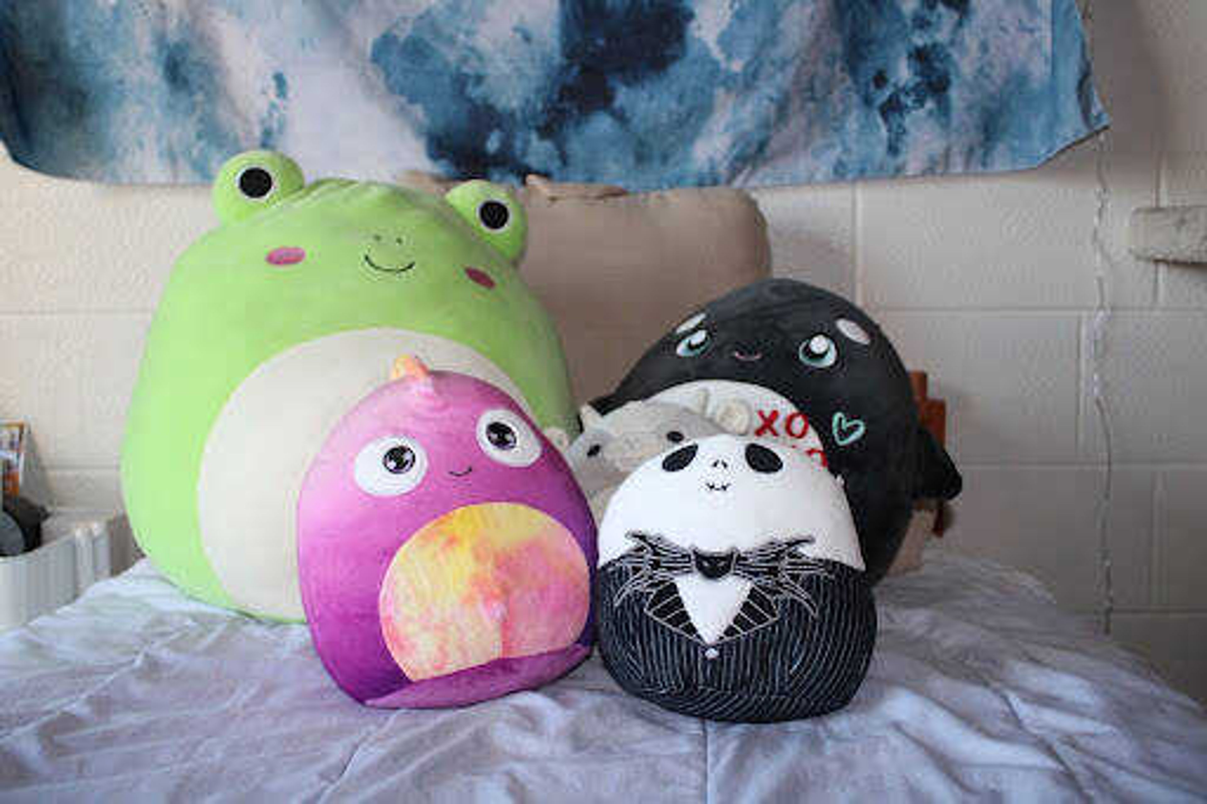 A collection of Squishmallows sit on Dominica Bowles’ bed, featuring two rare Squishes, the Jack Skellington and the scented mystery chameleon. They are a part of a large brand of stuffed animals which rose to fame after their debut on TikTok. 
