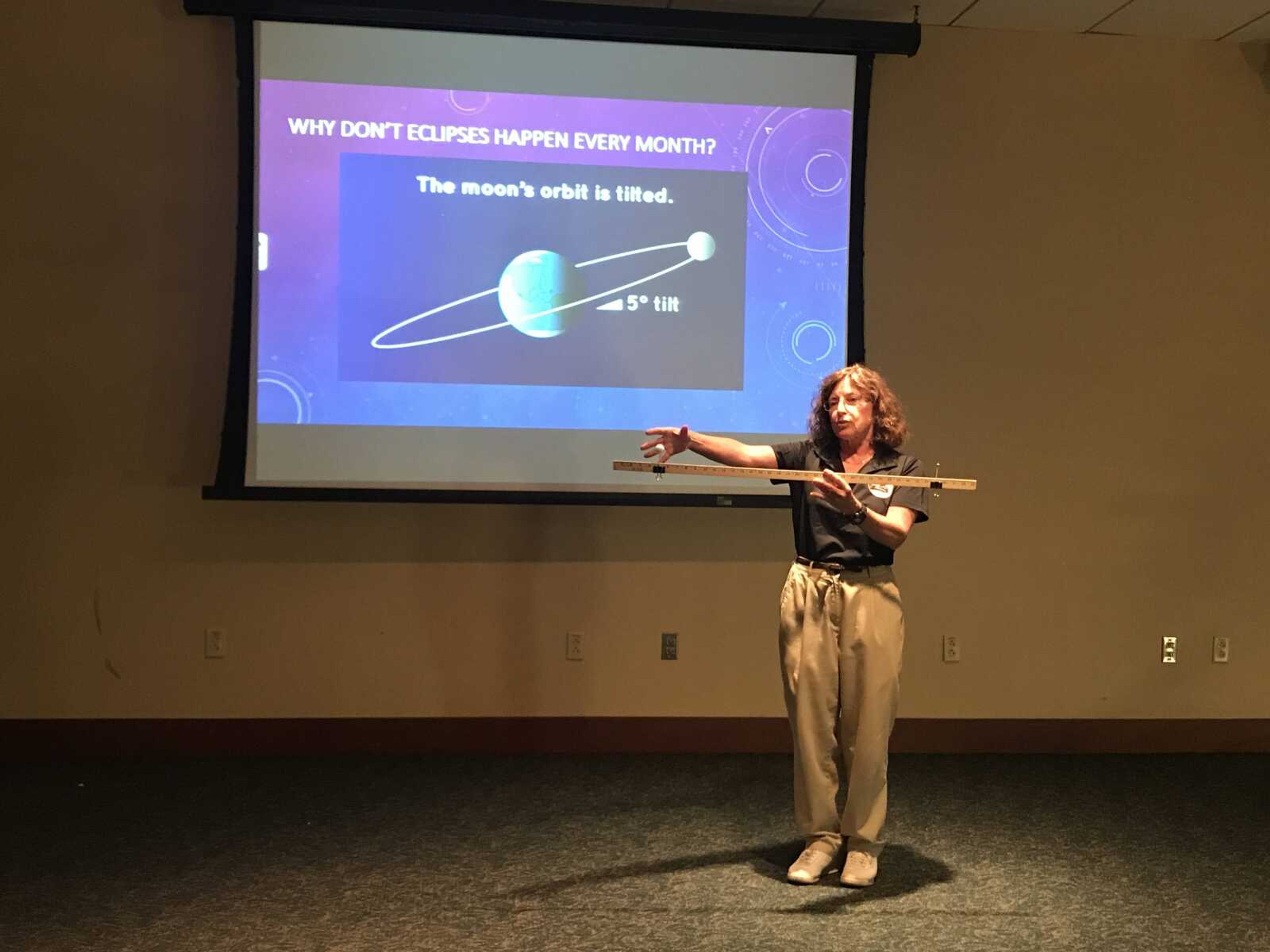 Dr. Margaret "Peggy" Hill explains her solar system model on Aug. 20 at Glenn Auditorium.
