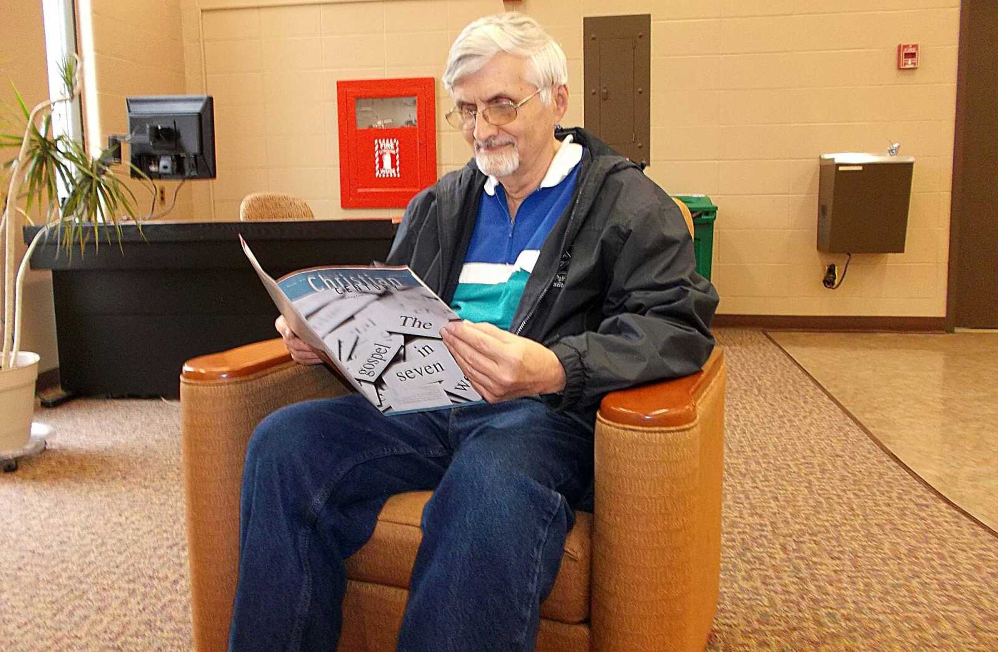Dr. John Coleman relaxing and reading at Kent Library on his break. Photo by Kelly Lu Holder