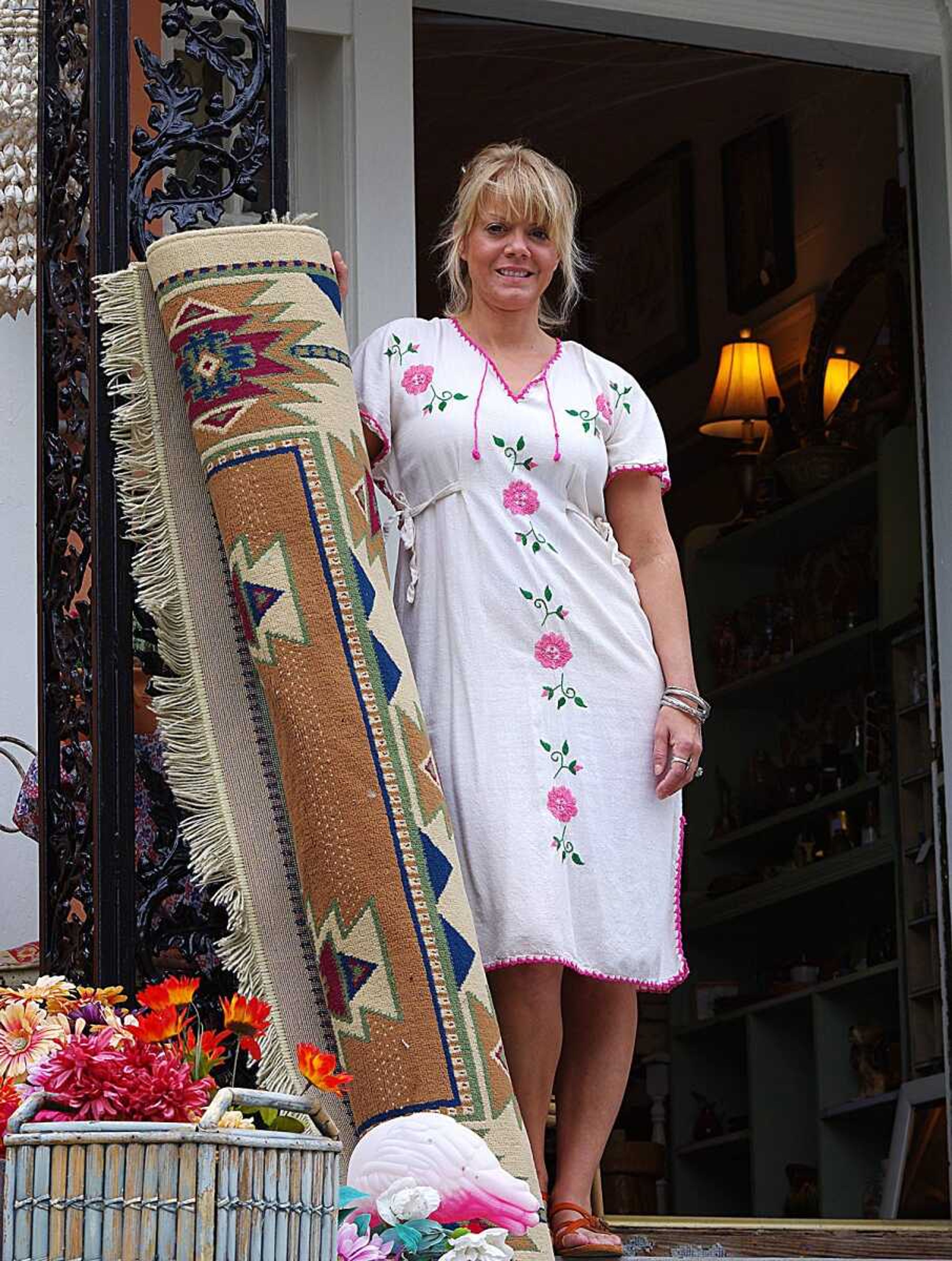 Laurie Everett brings out antiques to put on display before she opens the store for the day. Photo by Nathan Hamilton